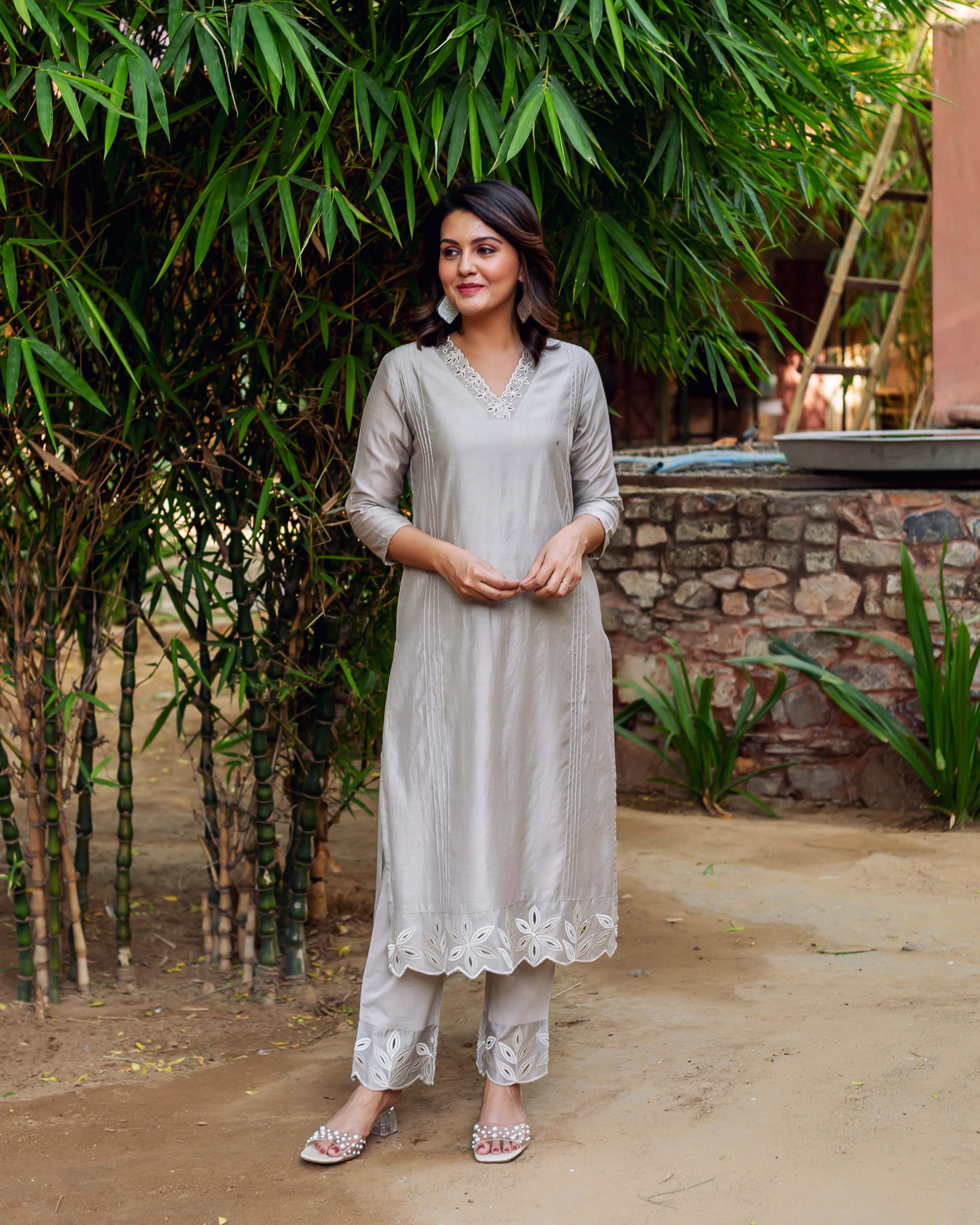 Model wears silver mist chanderi silk embroidered kurta and matching floral cutwork pants.