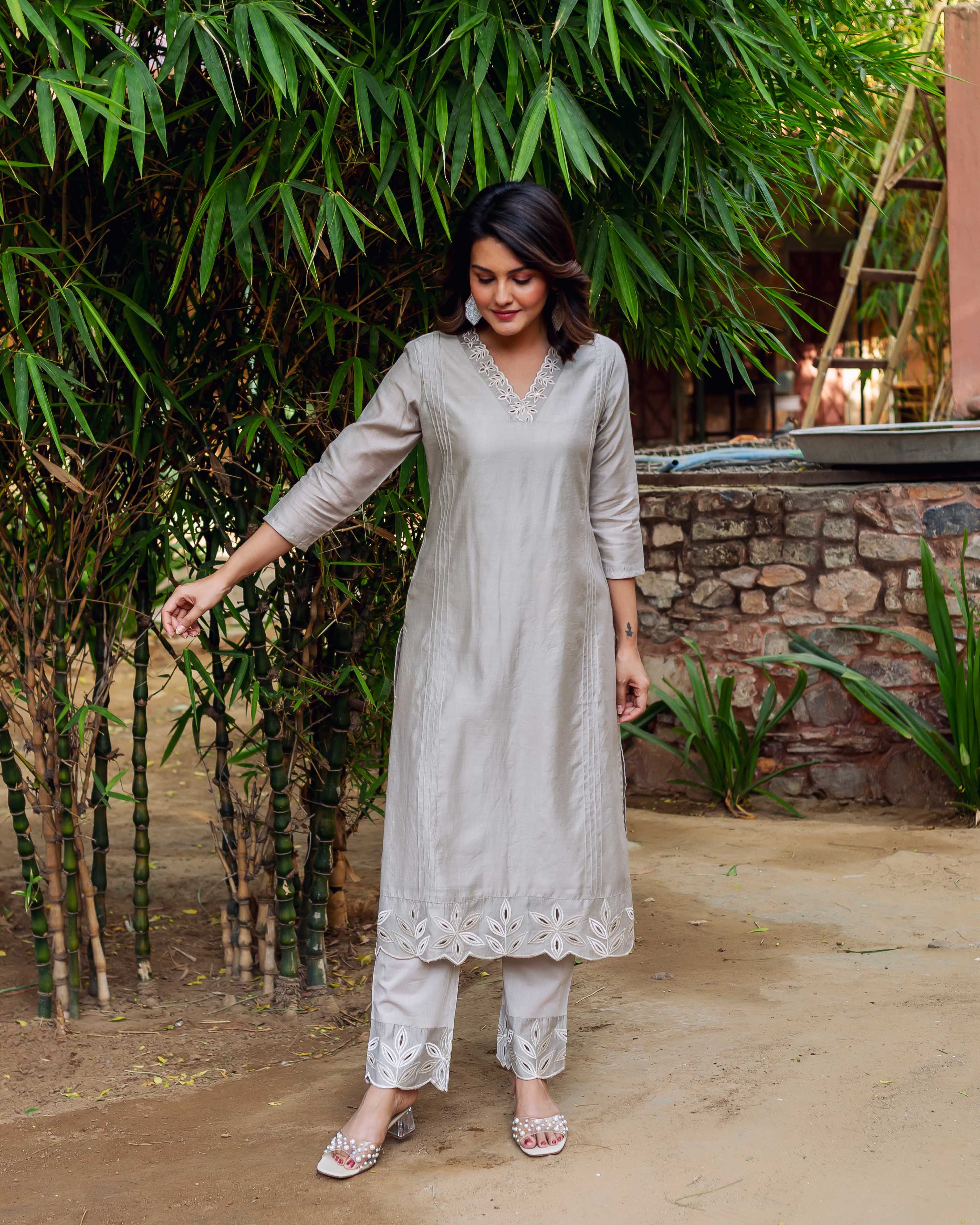 Model wears silver Chanderi silk embroidered kurta set with scalloped hems, by bamboo.