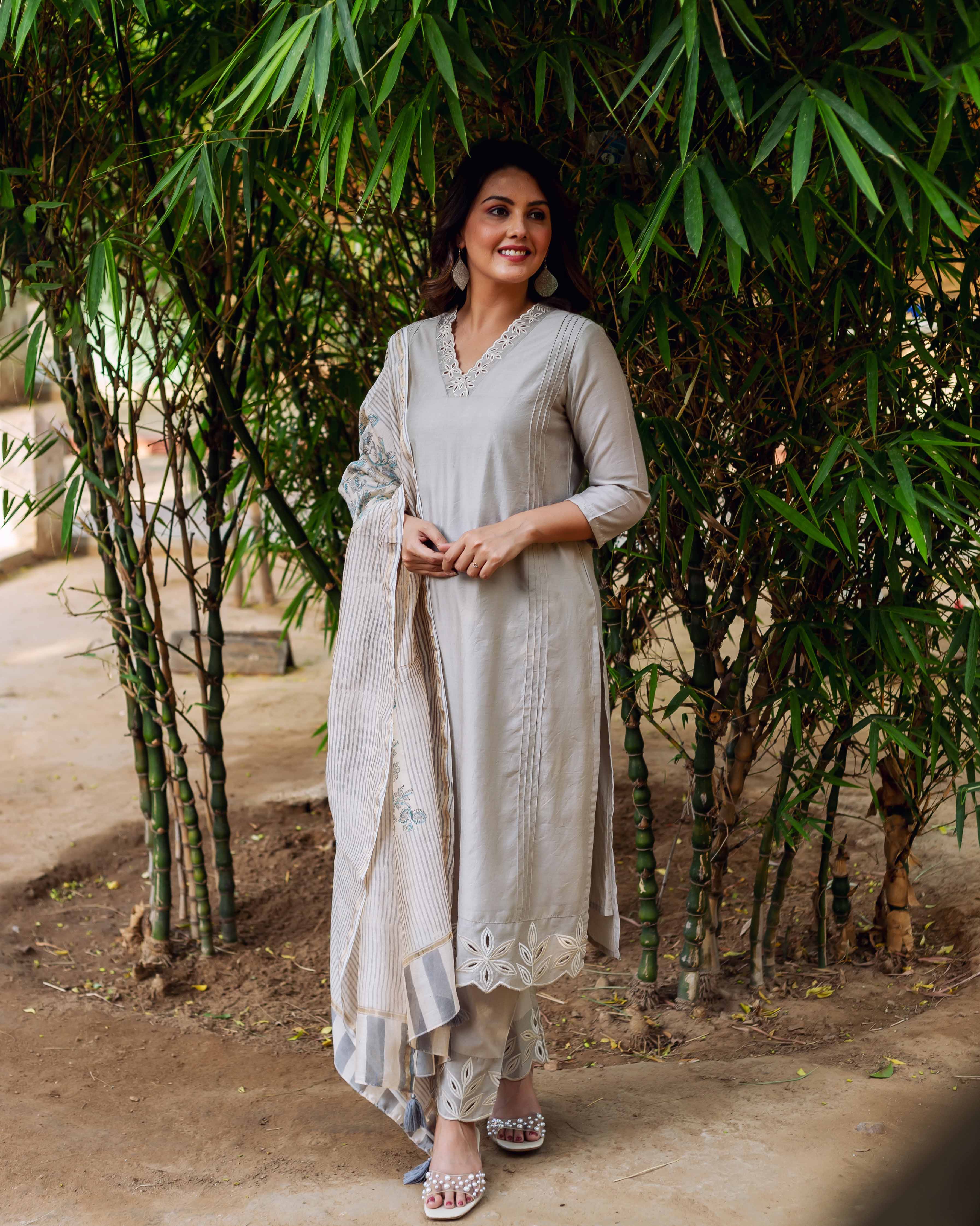 Woman in silver mist Chanderi silk embroidered kurta set, scalloped hems, hand-block-printed dupatta.
