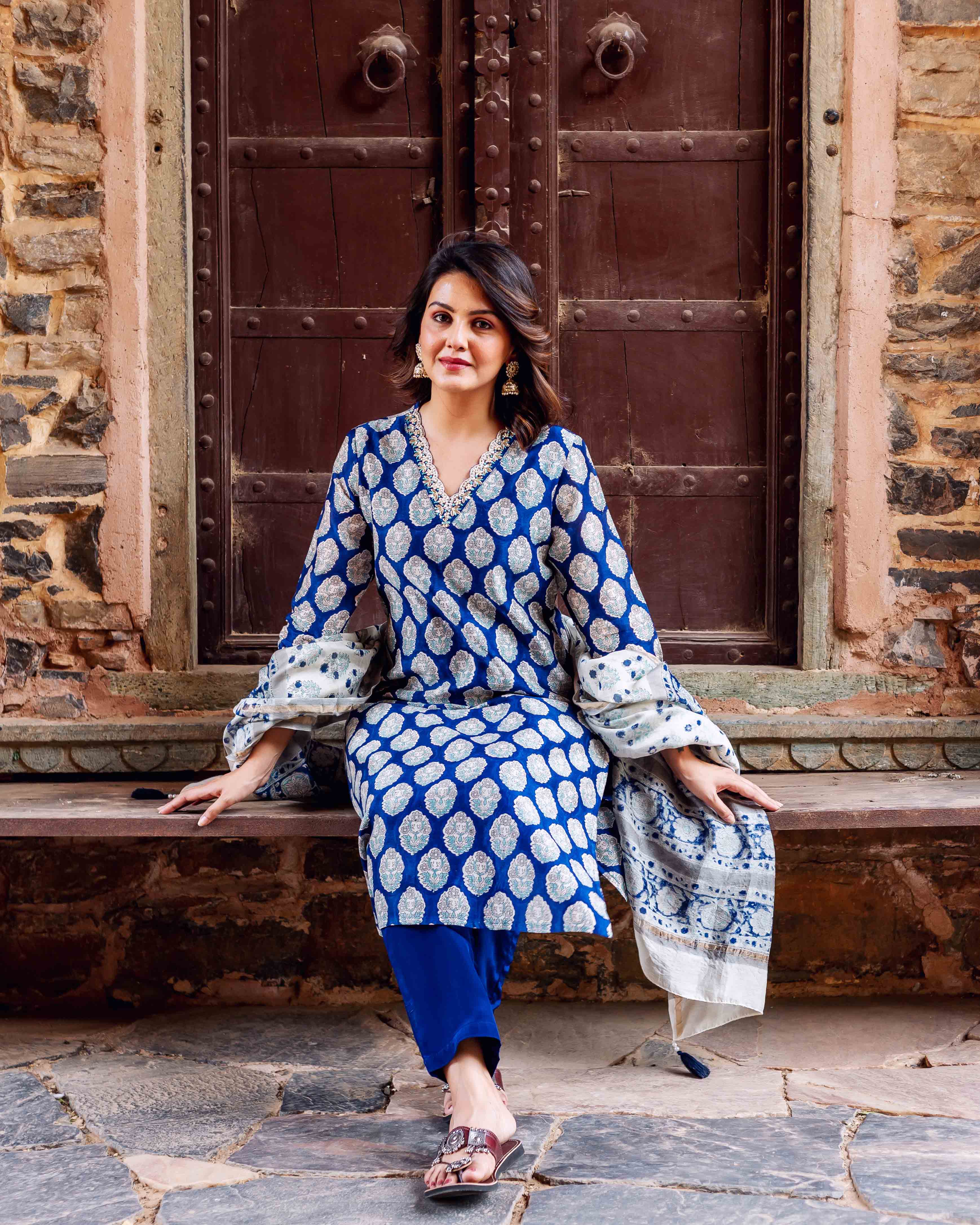 Model wearing indigo blue hand-block booti printed kurta with patterned dupatta and blue pants.