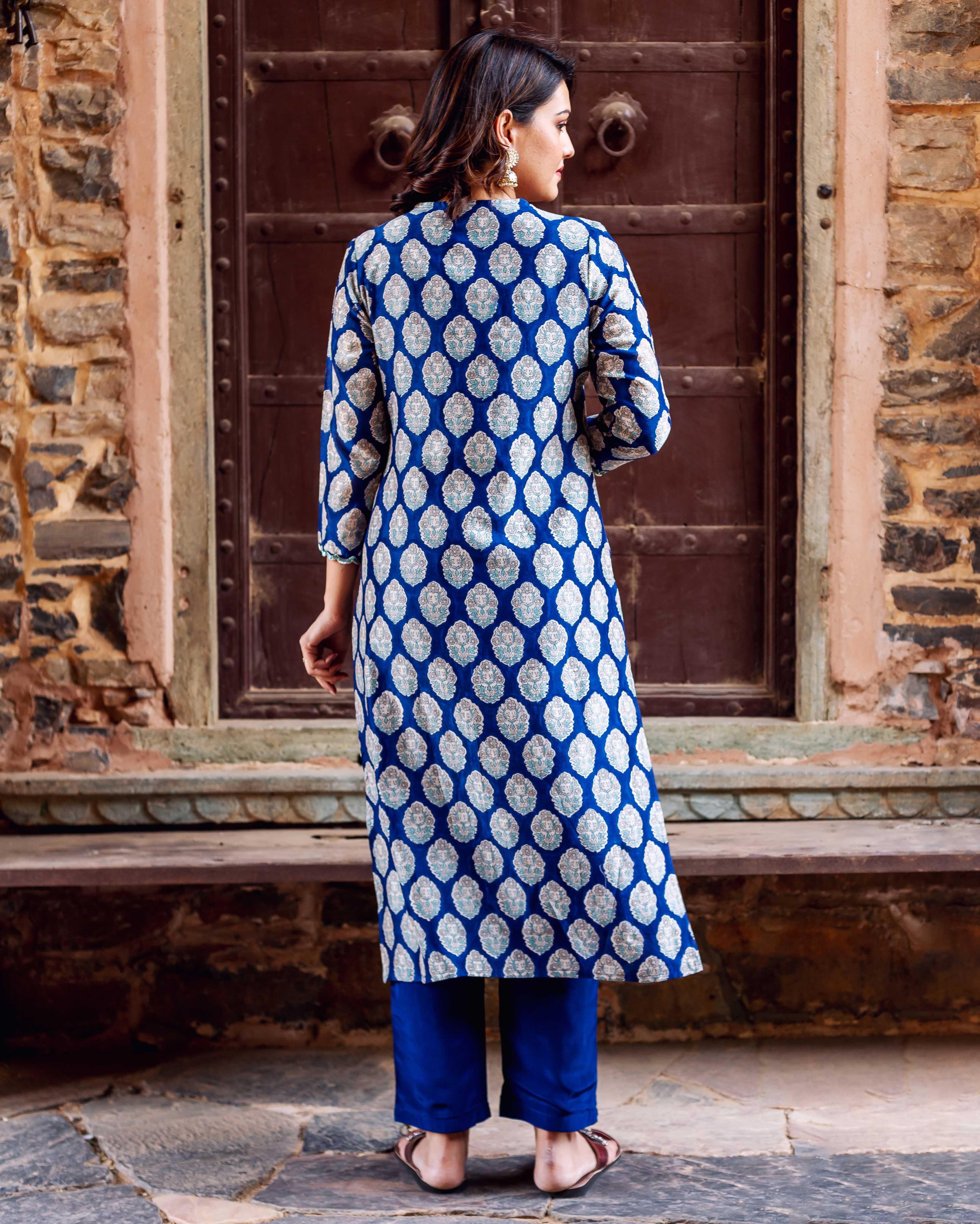 Back view of model wearing indigo blue booti chanderi silk kurta and blue pants.