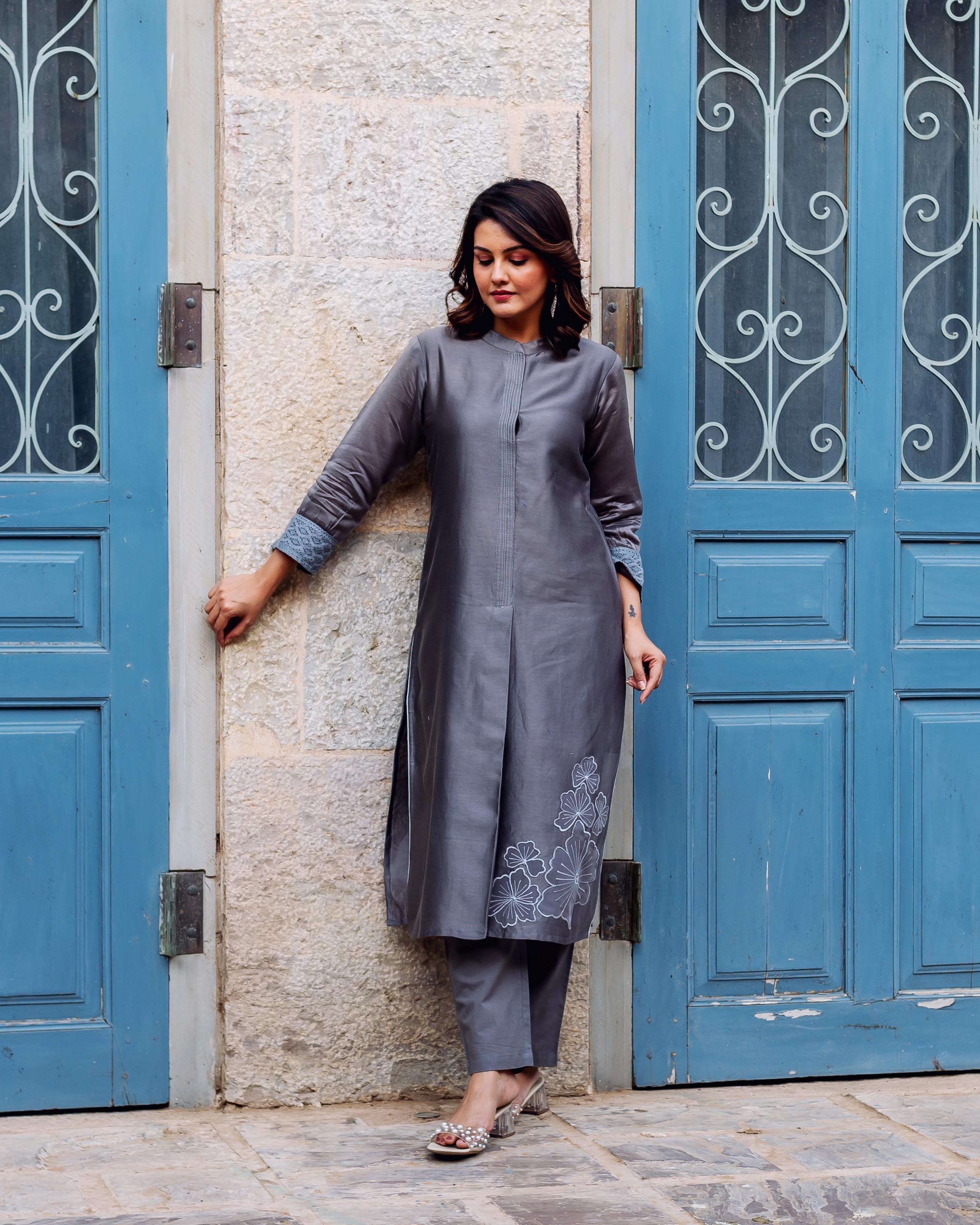 Model in a silver mist Chanderi silk kurta featuring white floral embroidery and patterned cuffs.