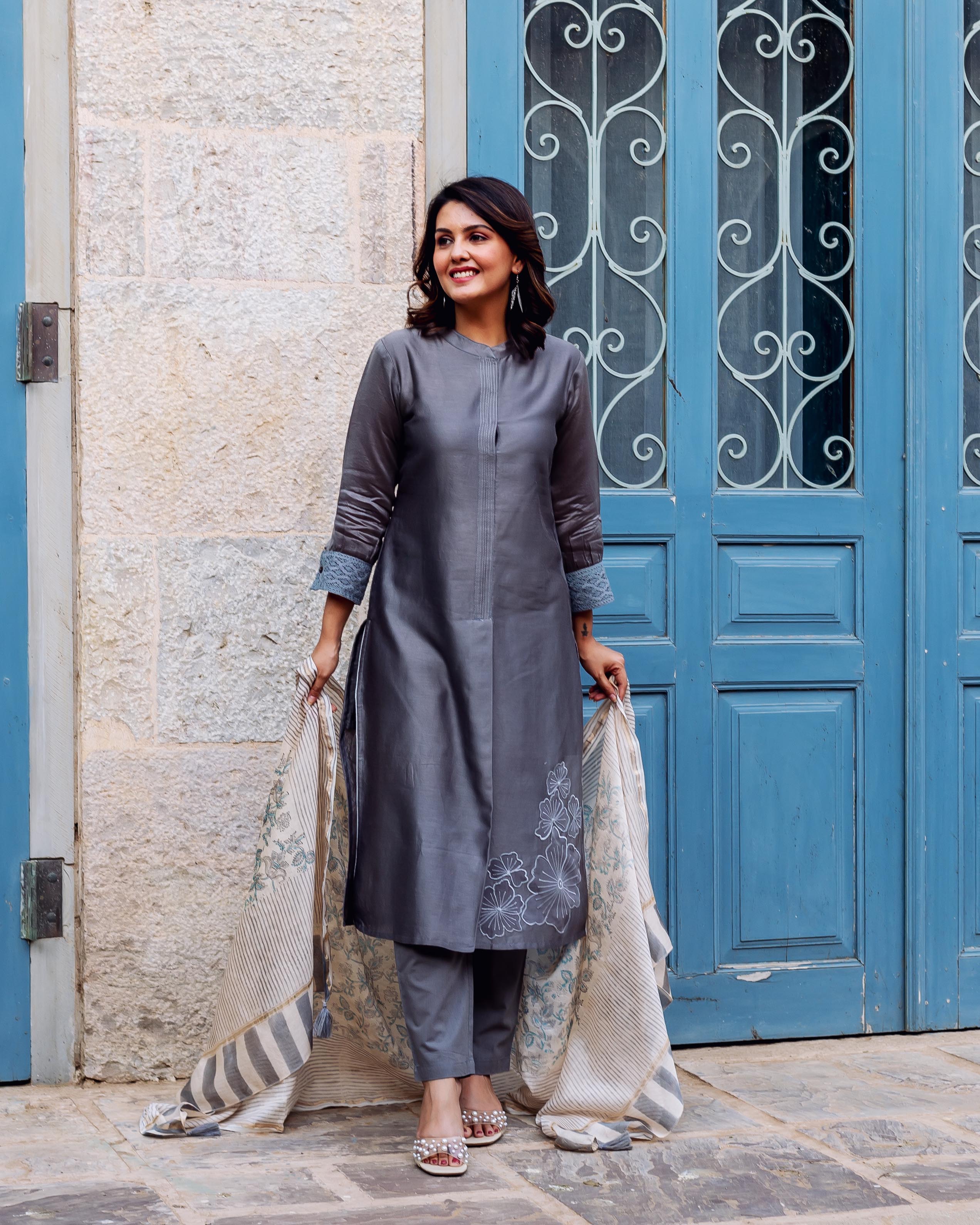Full-length of woman in silver mist chanderi silk embroidered kurta set with block-printed dupatta.