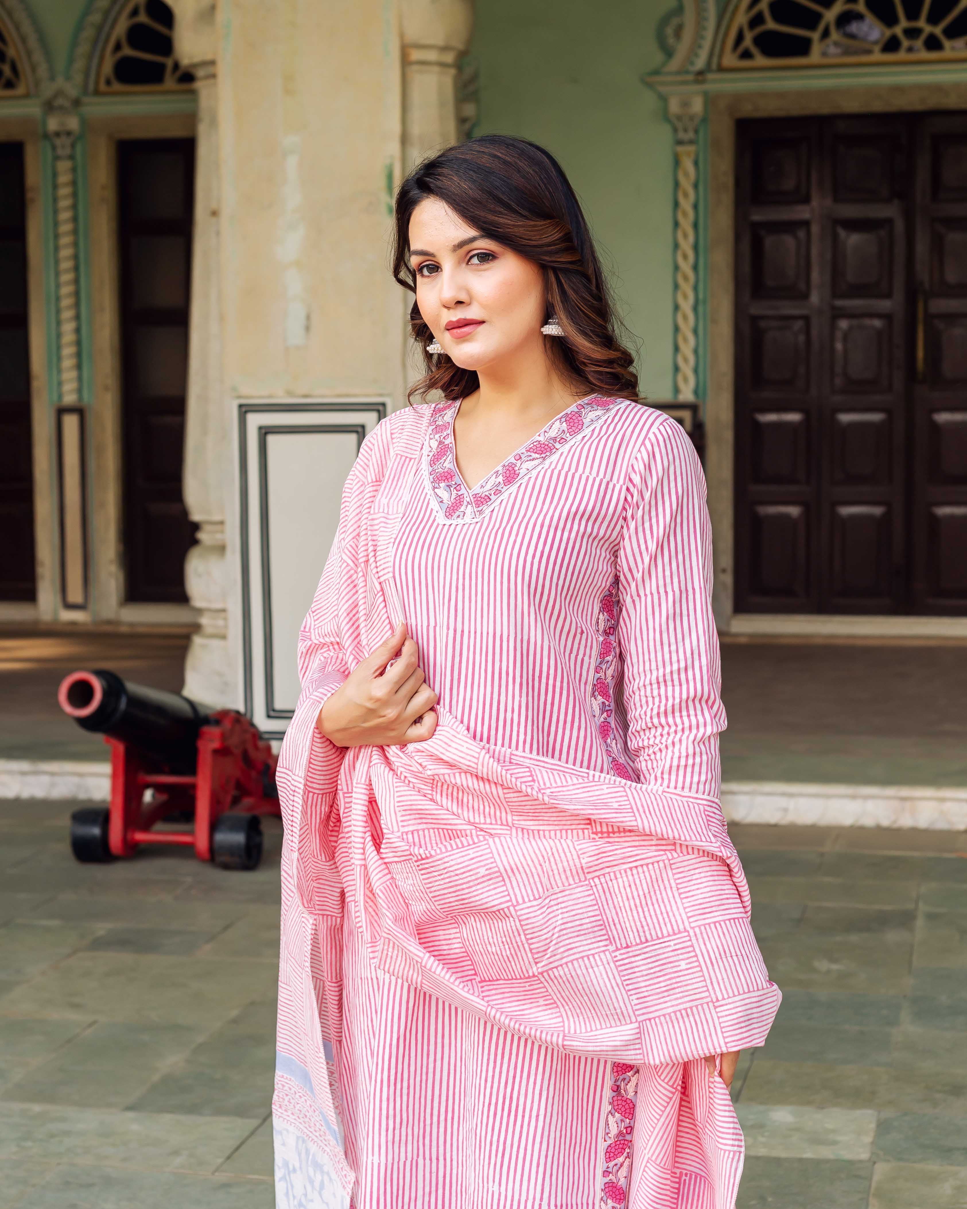 Model wears a white and pink striped hand-block print kurta with matching dupatta.