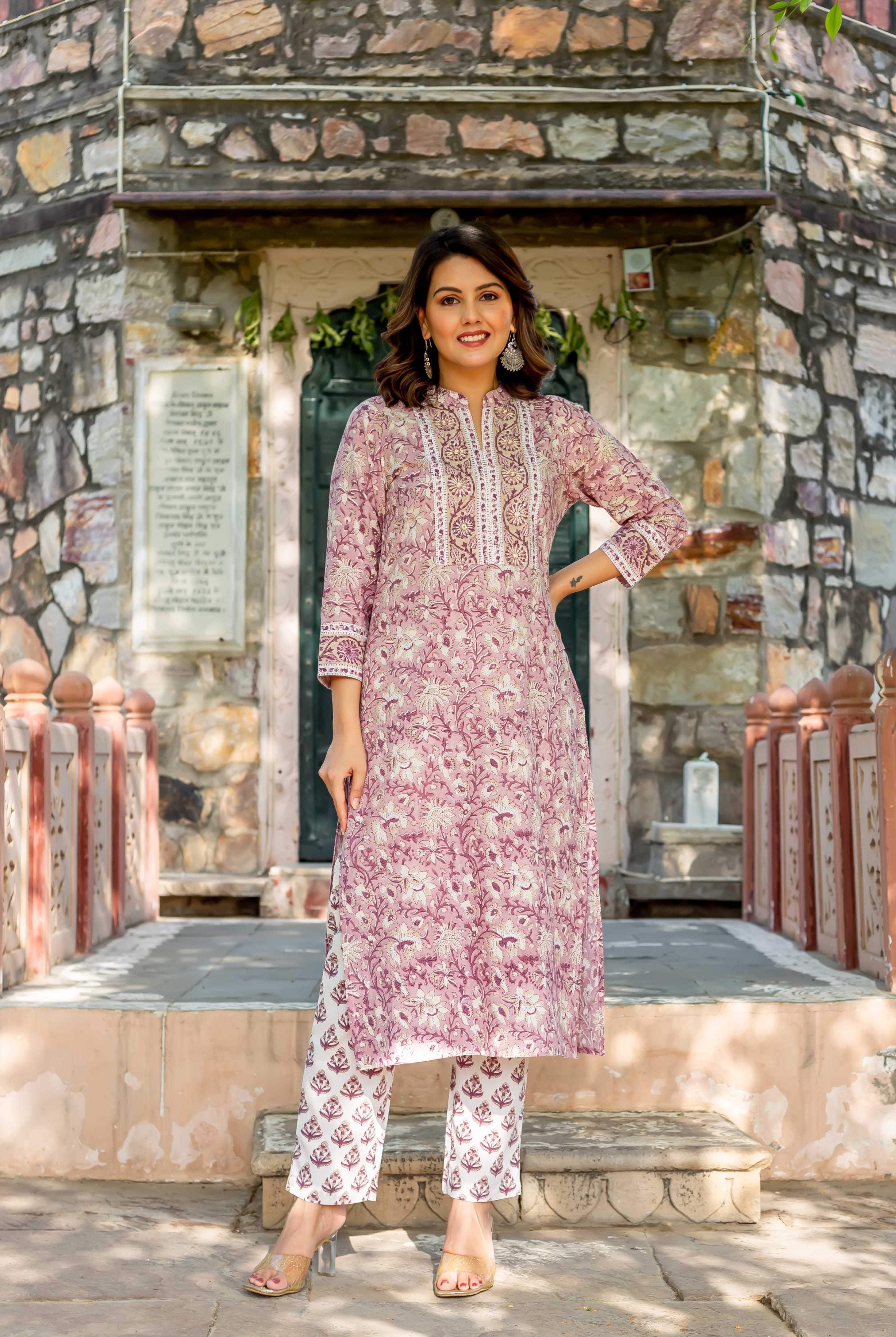 Smiling woman in full-length old rose hand-block-printed cotton kurta and white ethnic pants.