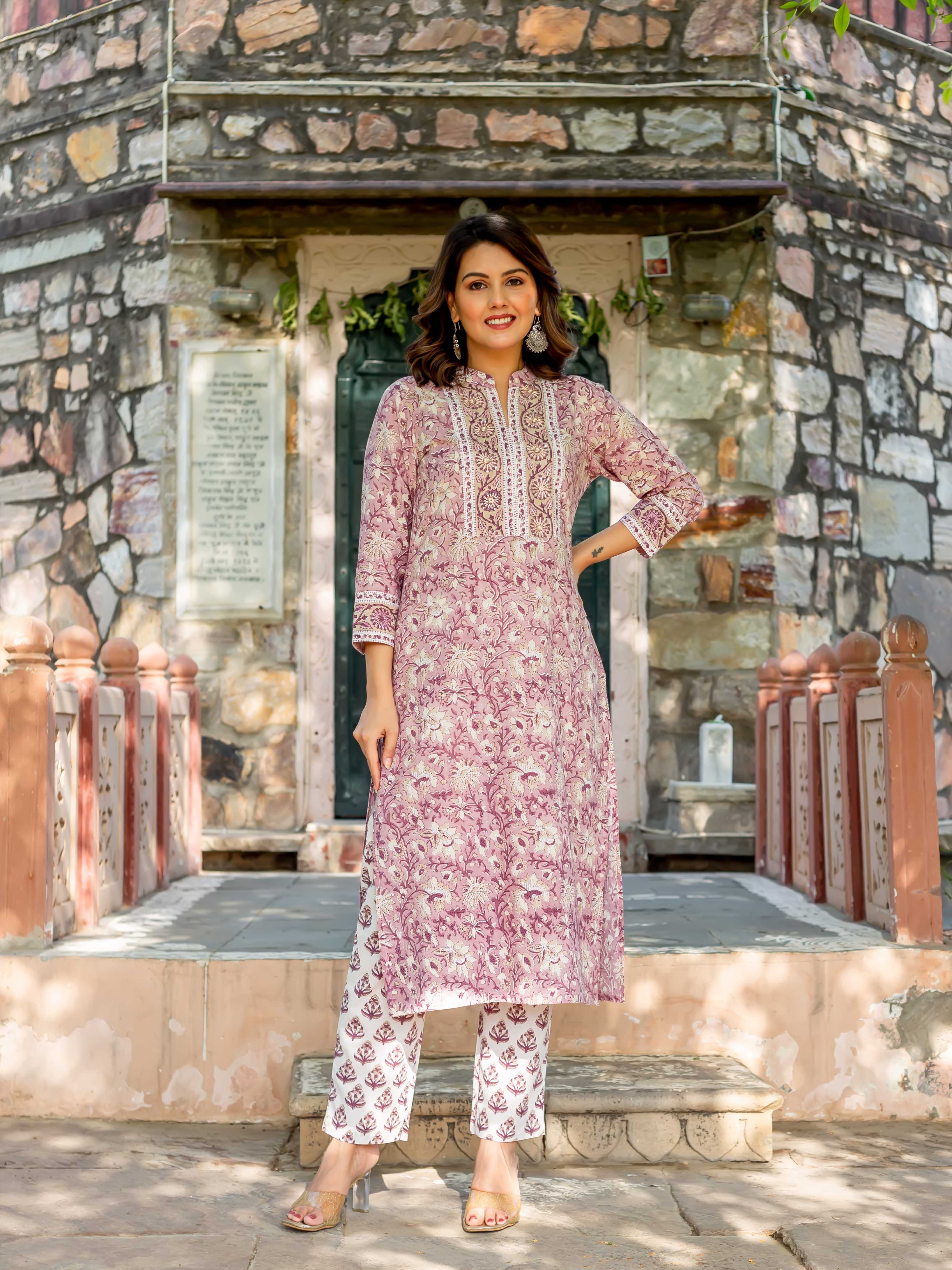 Smiling woman in full-length old rose hand-block-printed cotton kurta and white ethnic pants.