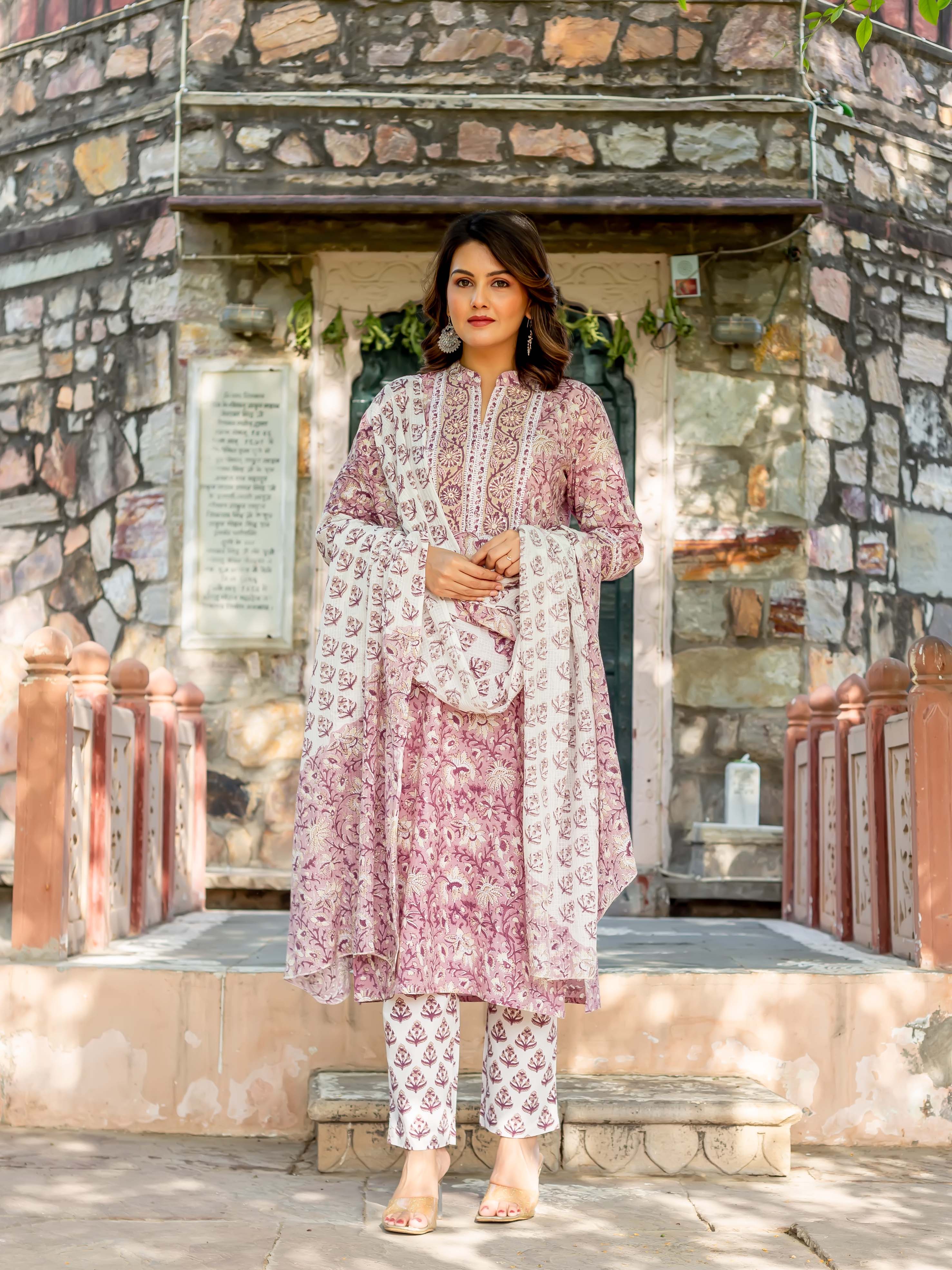 Woman models a full old rose and white hand-block printed cotton kurta set.