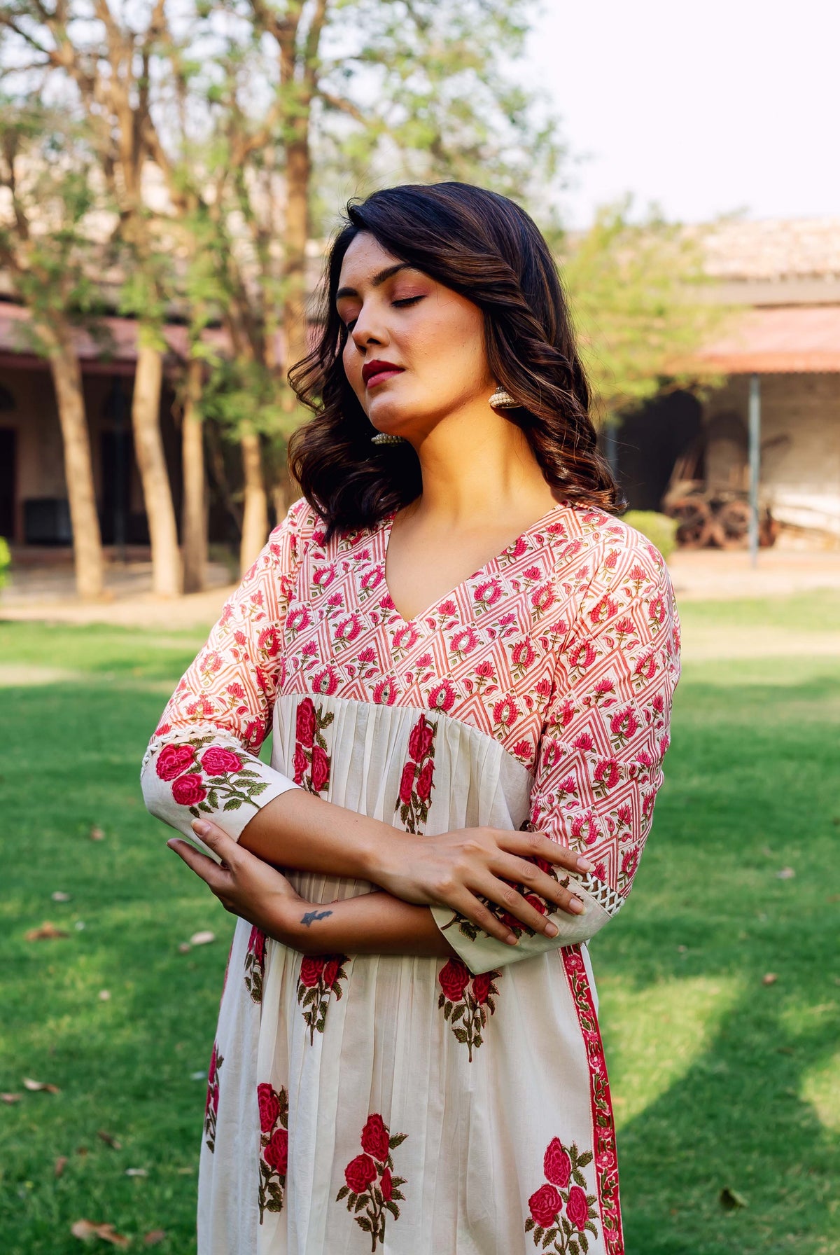 Model in a white and red hand-block-printed ethnic kurta with floral patterns.