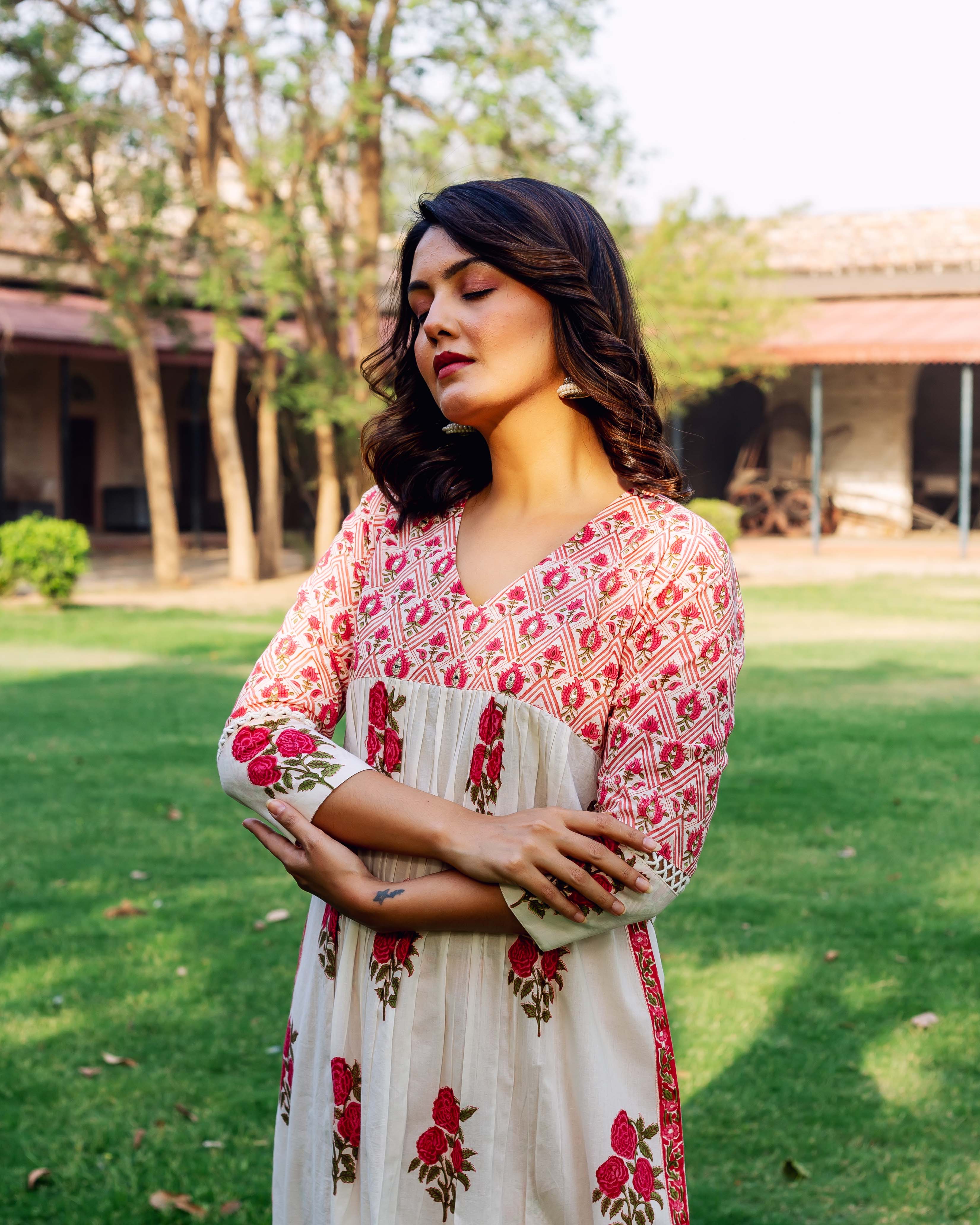 Model in a white and red hand-block-printed ethnic kurta with floral patterns.