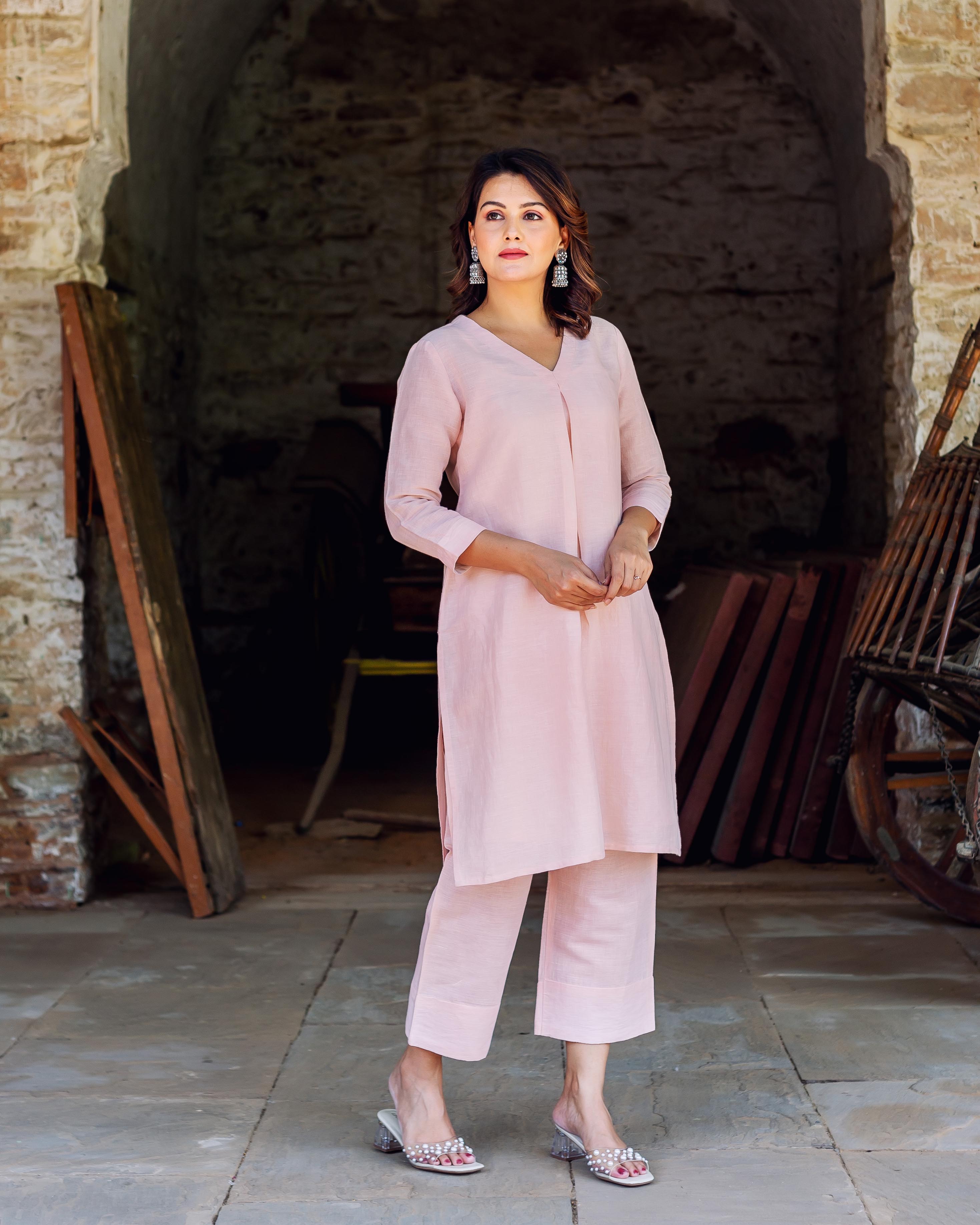 Front view of a woman wearing a plain light pink linen co-ord set.
