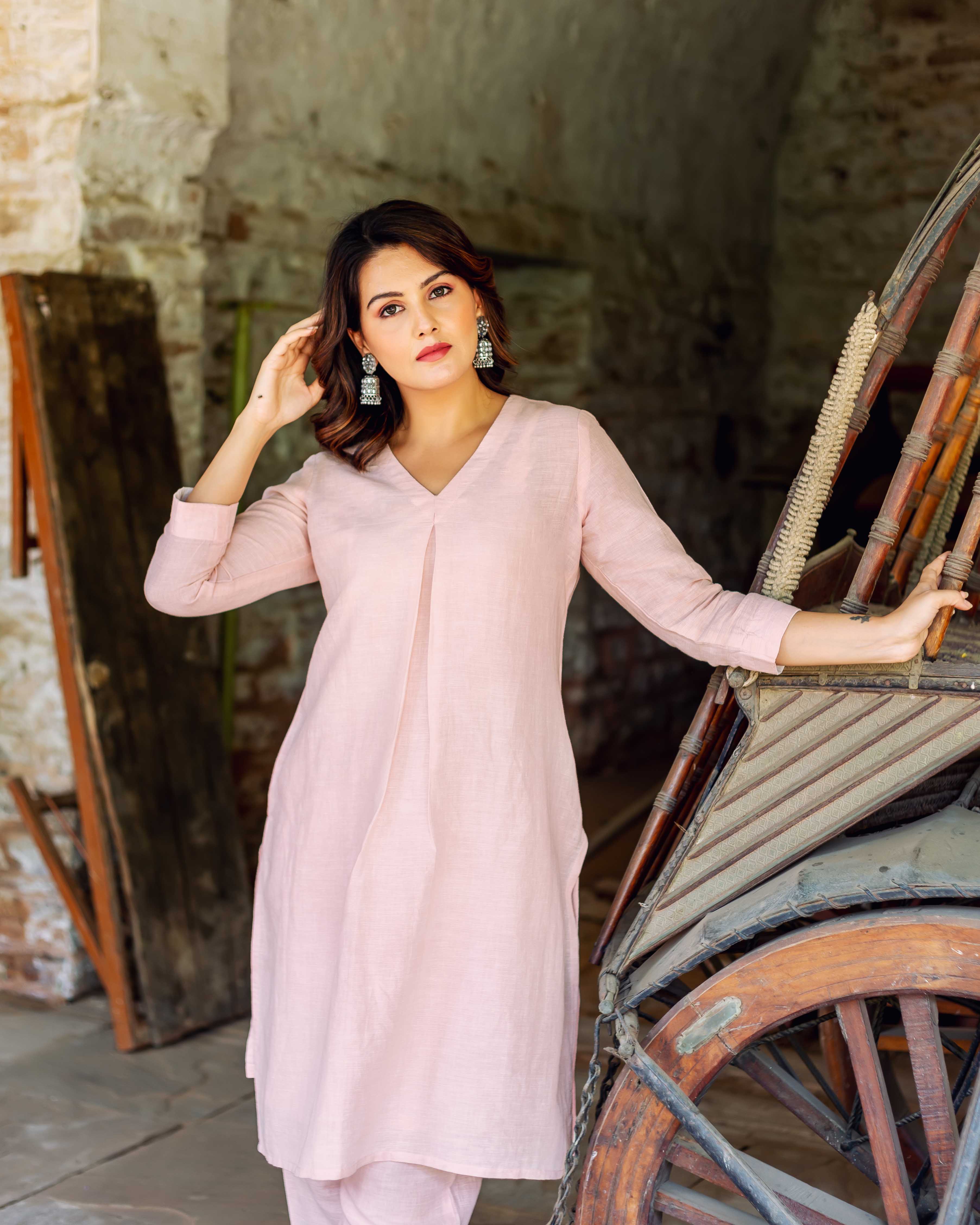 Front view model wearing a full look of plain pink linen V-neck kurta co-ord set.