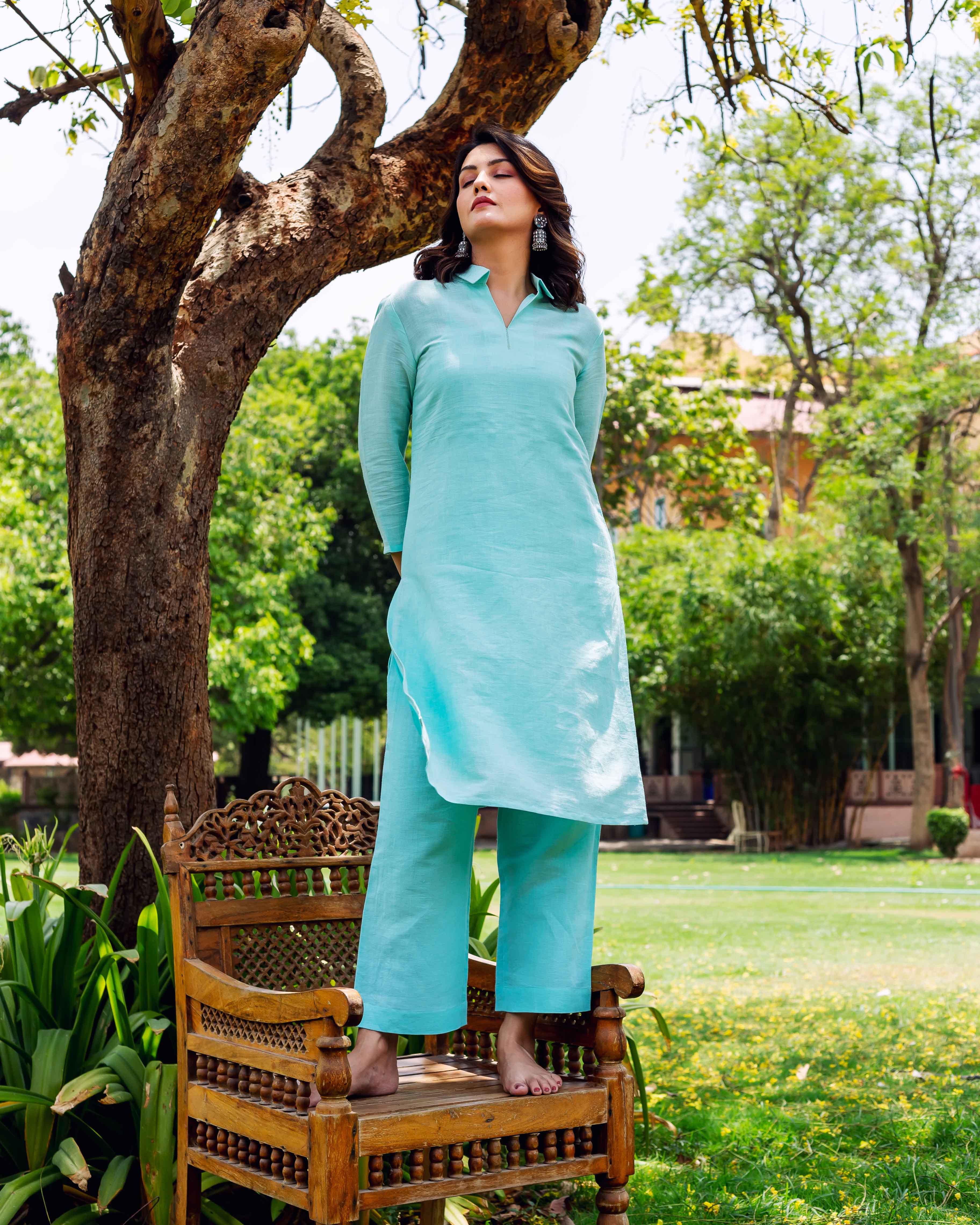 Full front view of model in plain bright sky blue linen co-ord set.