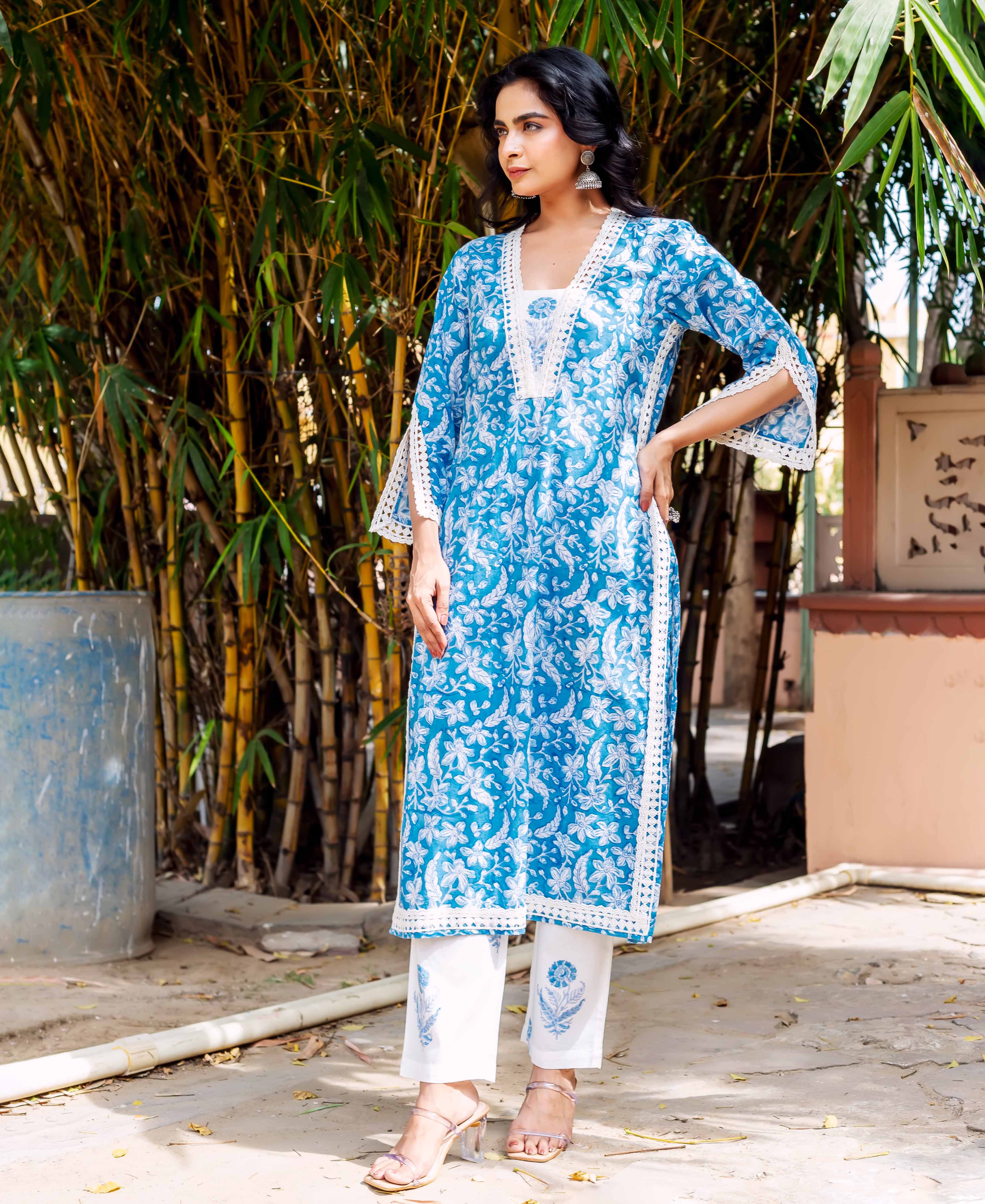 Full look of model in blue and white floral printed kurta set with white lace.