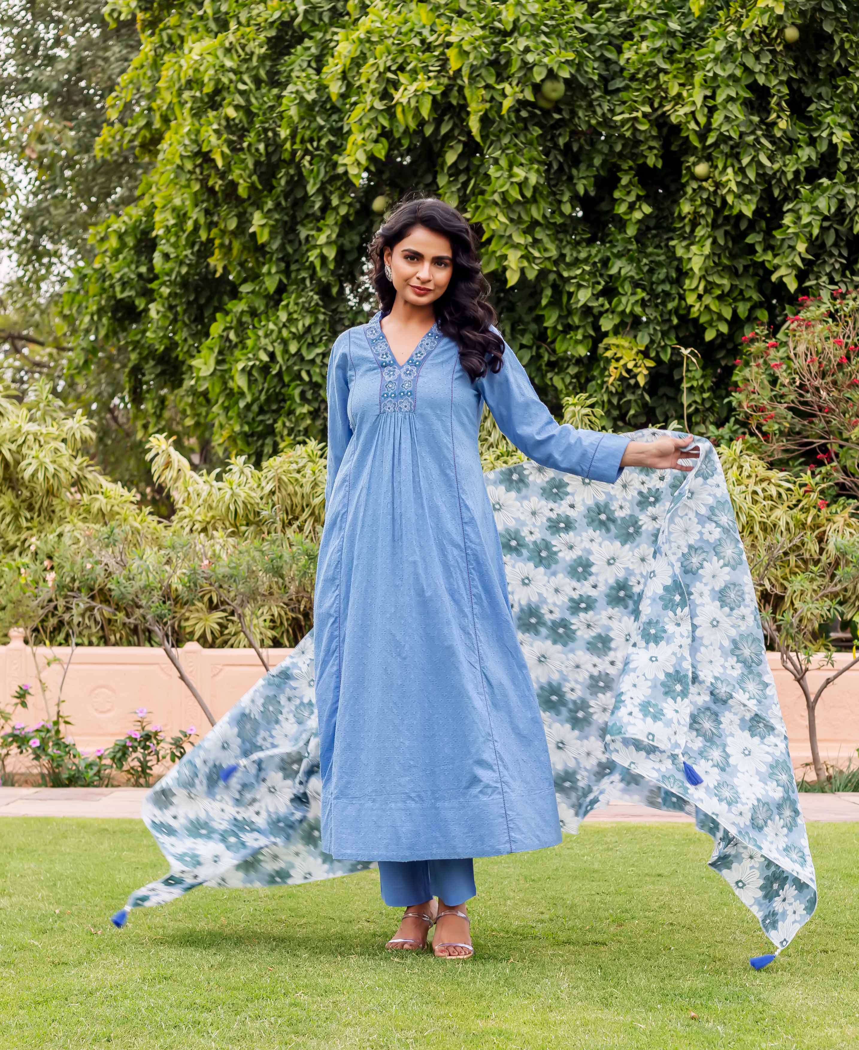 Full length model in light blue embroidered Anarkali kurta and white-teal floral dupatta.
