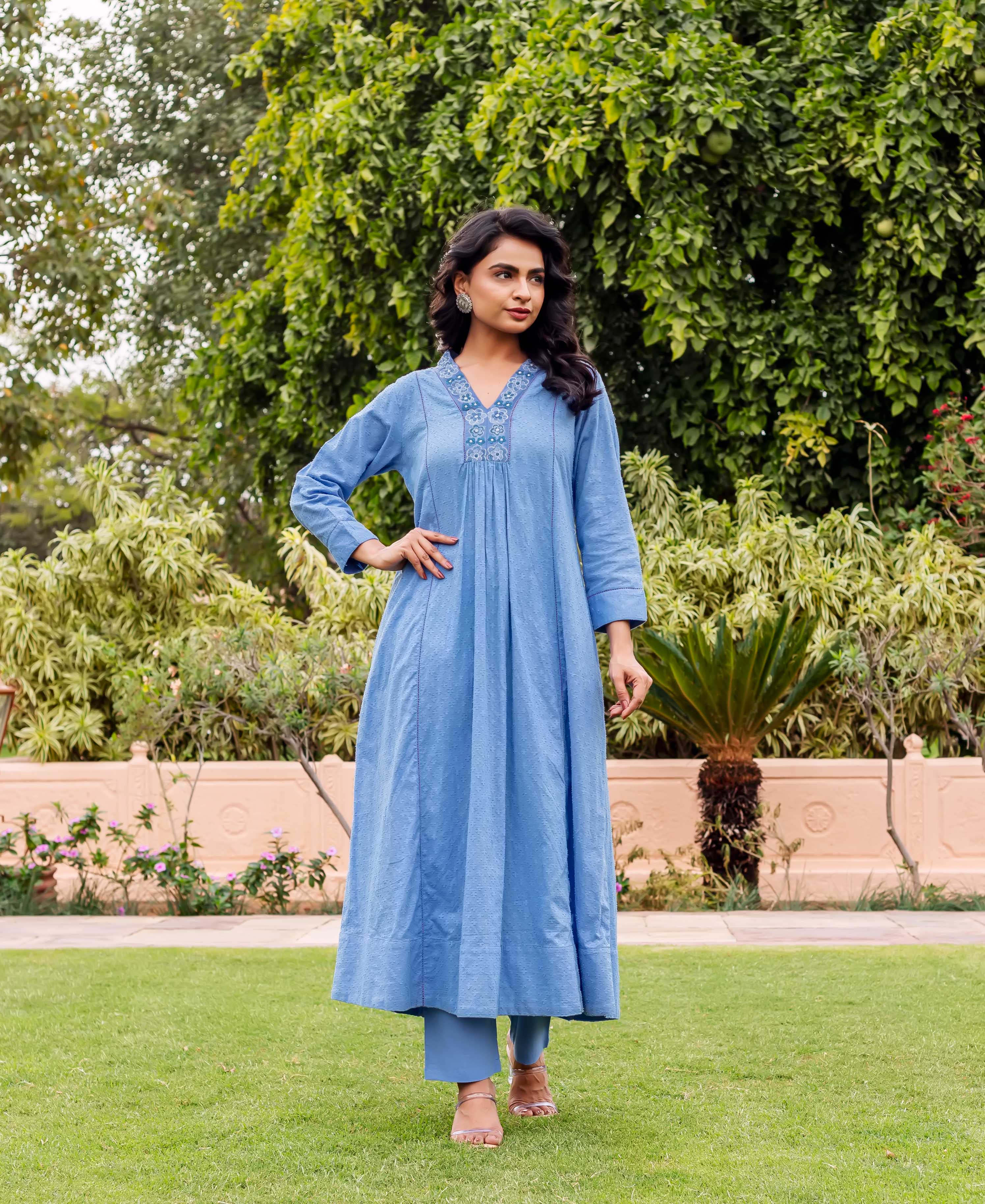 Model in sky blue cotton Anarkali kurta set with subtle white dotted hand-block print and embroidered yoke.
