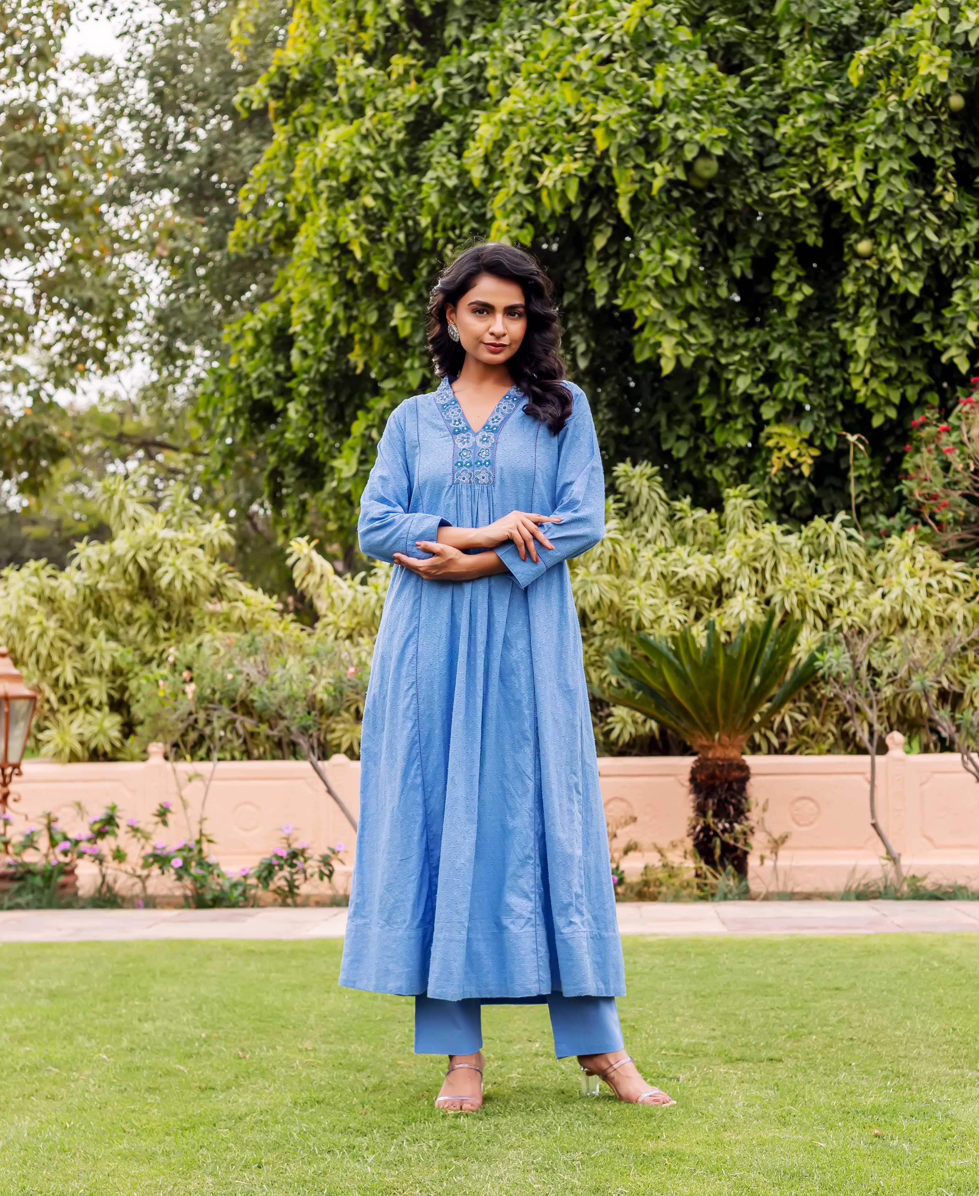Standing model in a sky blue Anarkali kurta with subtle hand-block print and embroidered neckline.