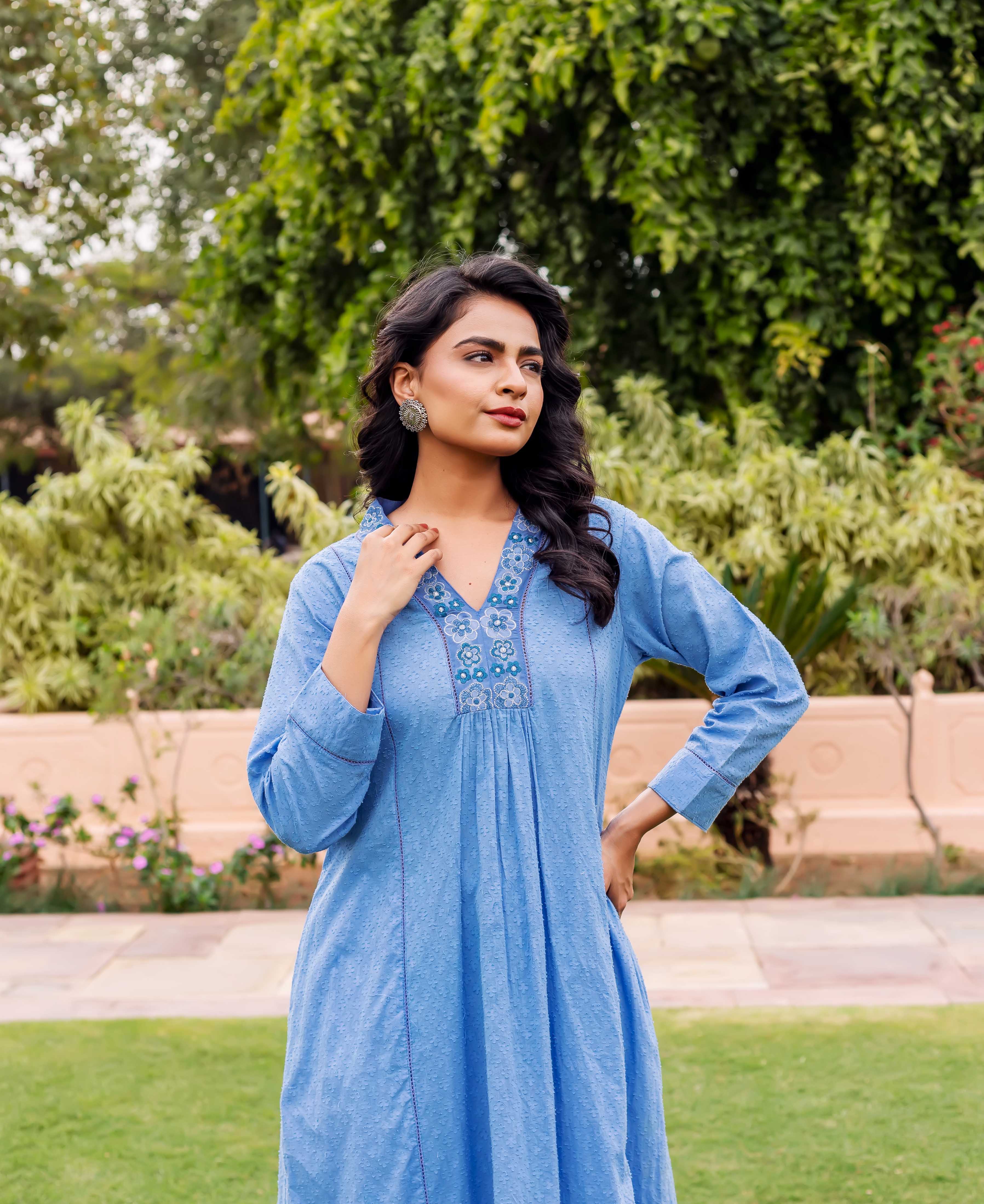 Model in sky blue Anarkali kurta featuring embroidered V-neck and subtle hand-block dots.