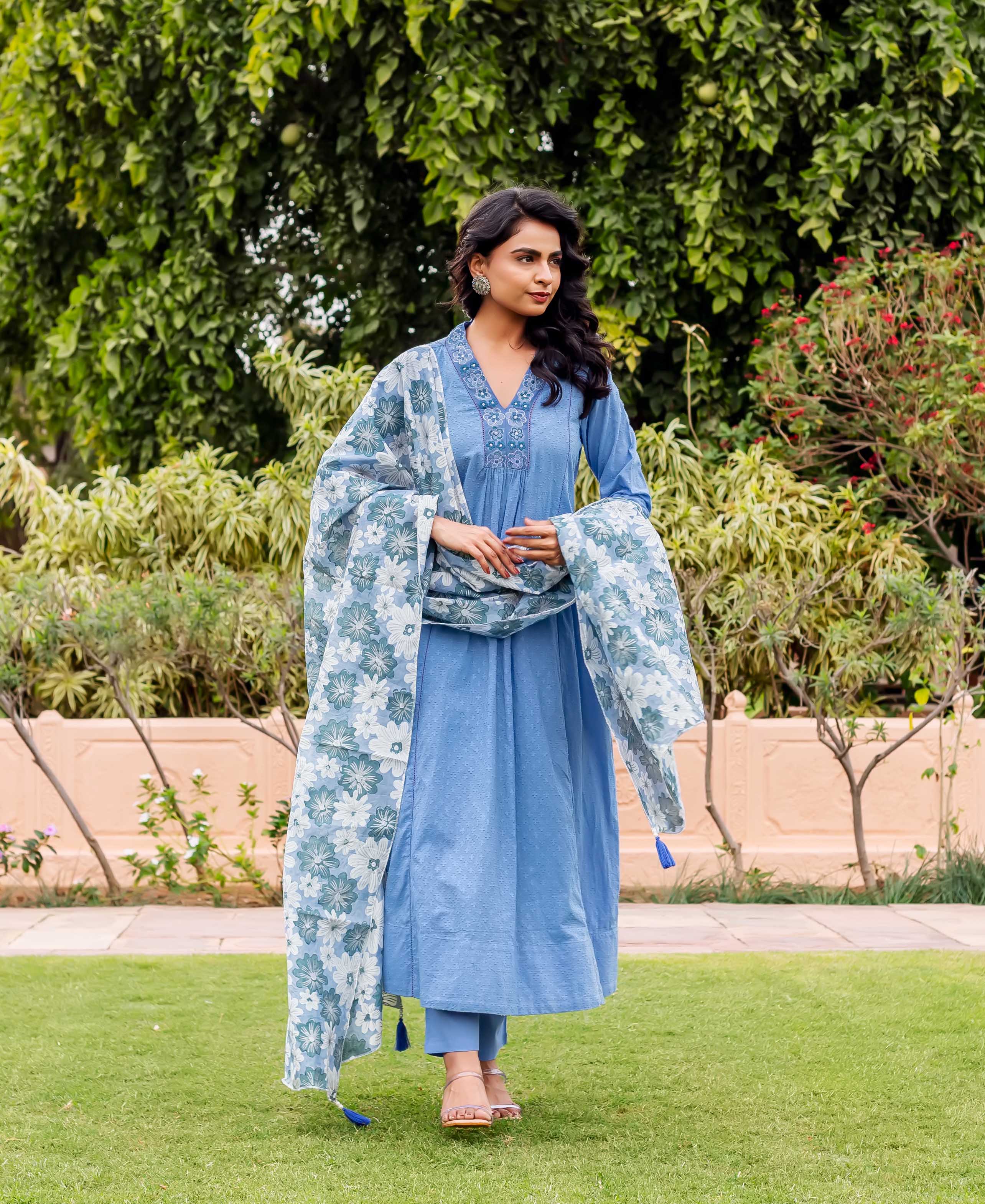 Model in sky blue anarkali kurta set with a white and blue floral block-printed dupatta.