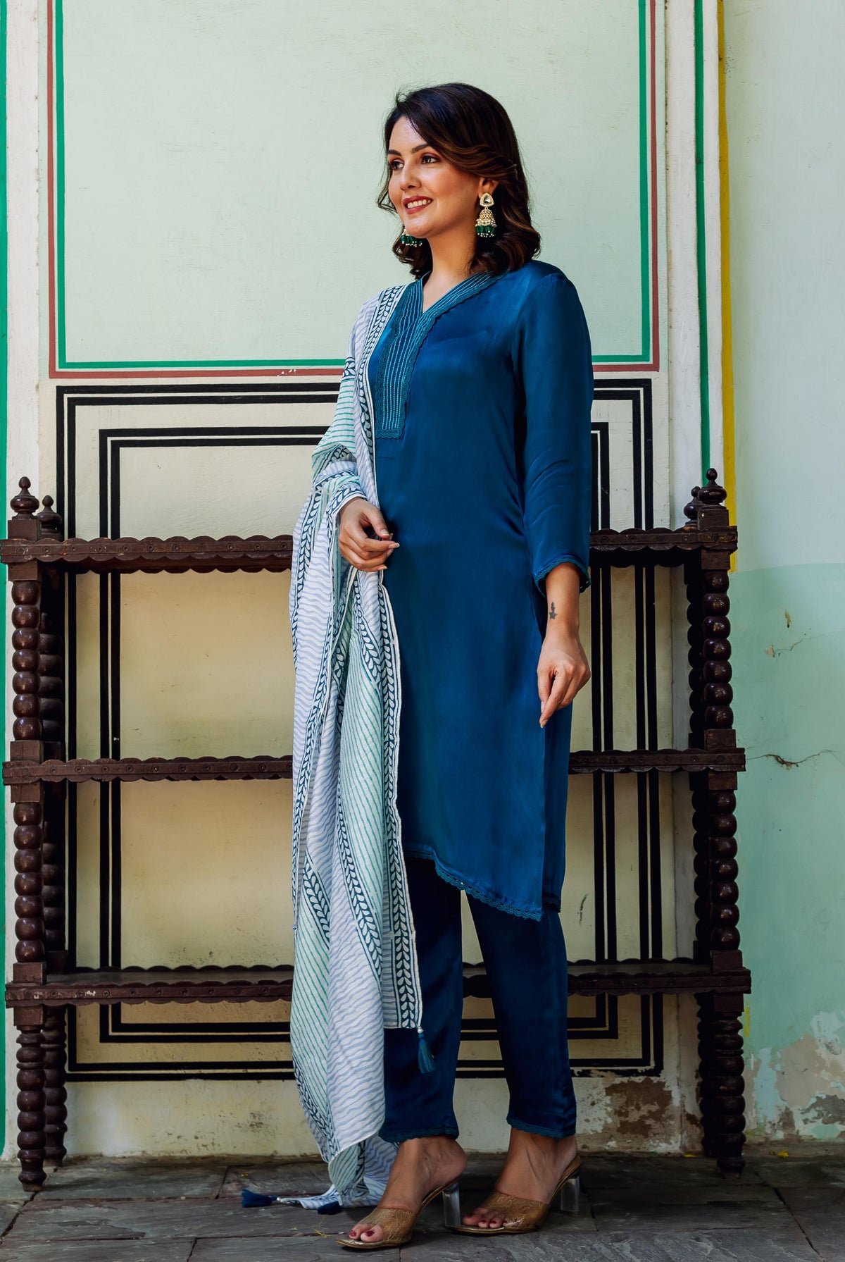 Model wearing royal blue satin kurta set with a white and blue hand-block-printed ethnic dupatta.
