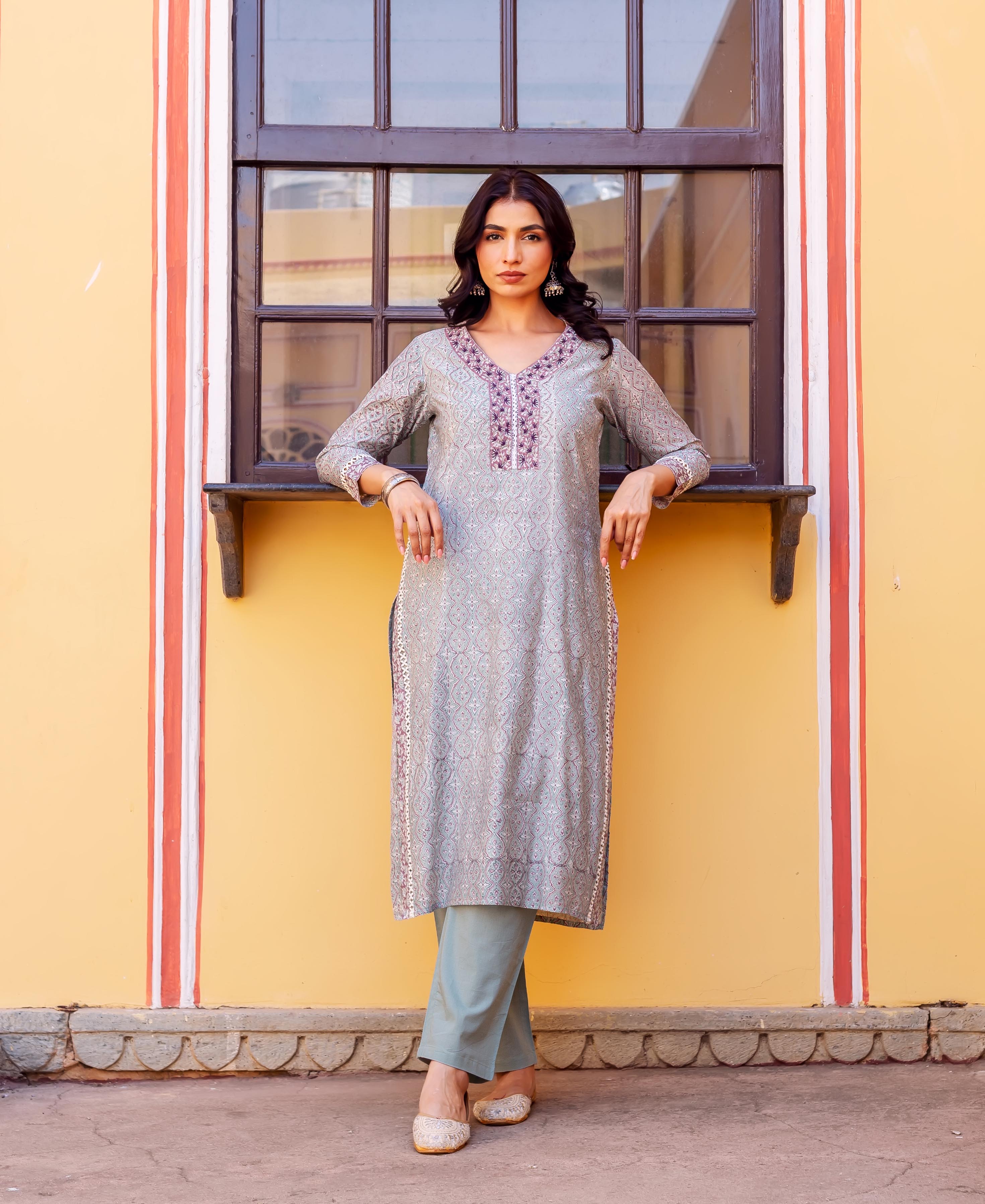 Model wears full-length grey block-printed chanderi kurta with embroidered neckline and light blue pants.