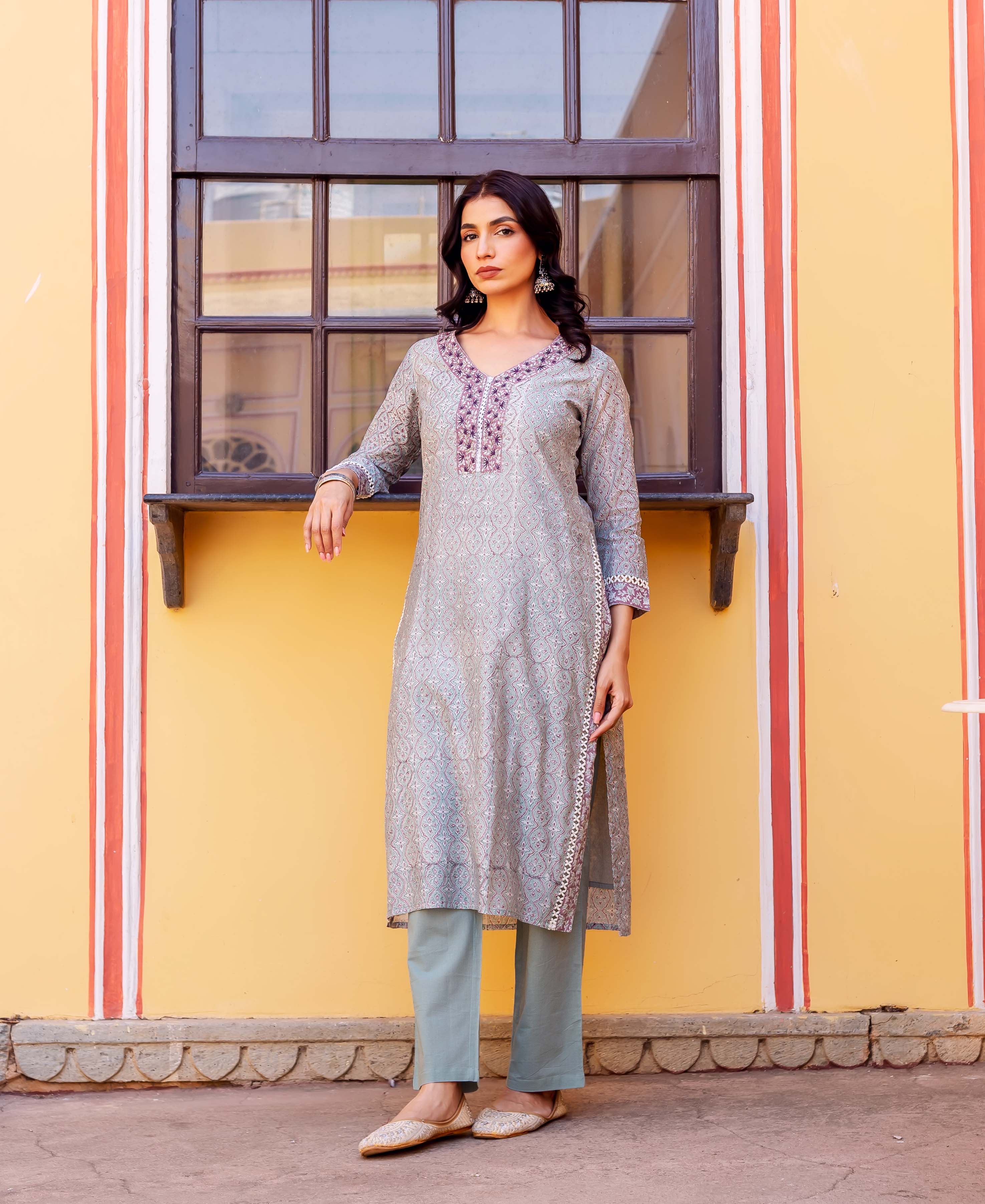 Model in a grey block-printed chanderi kurta set with intricate patterns and purple embroidered yoke.