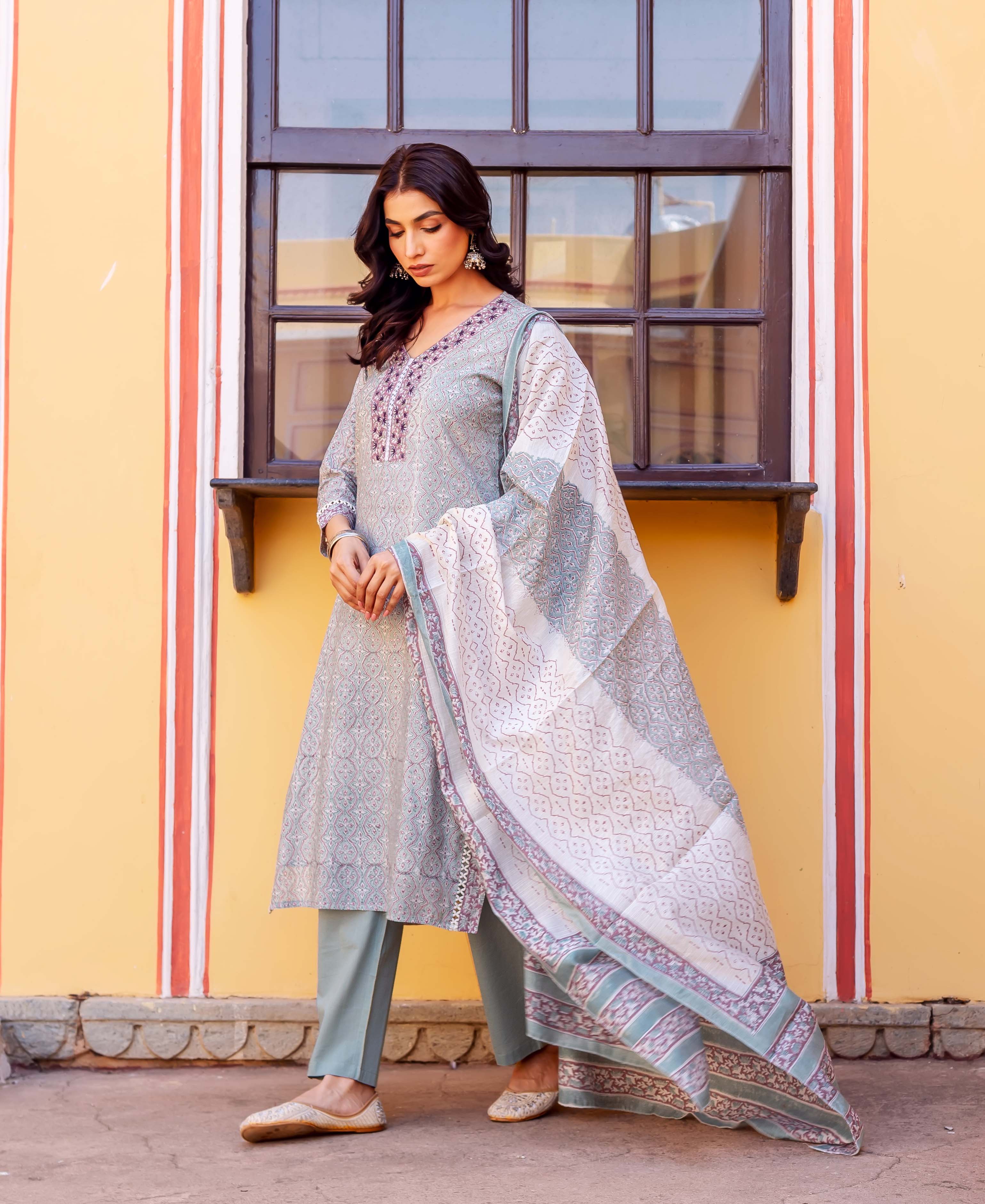 Full-length model in light blue block-printed kurta set with embroidered neckline and matching dupatta.