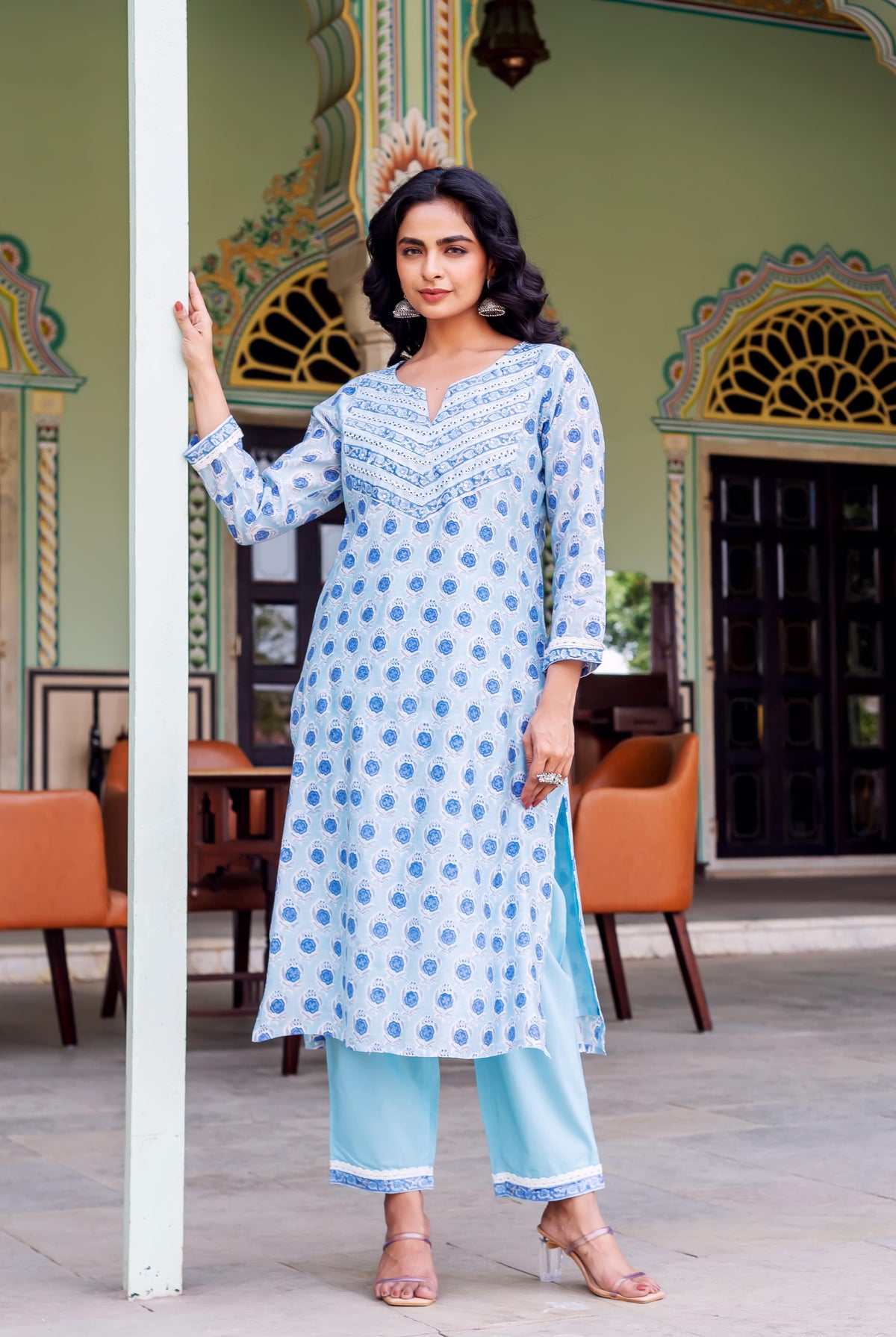 Model in light blue ethnic hand-block-printed kurta set with patterned yoke and pants.