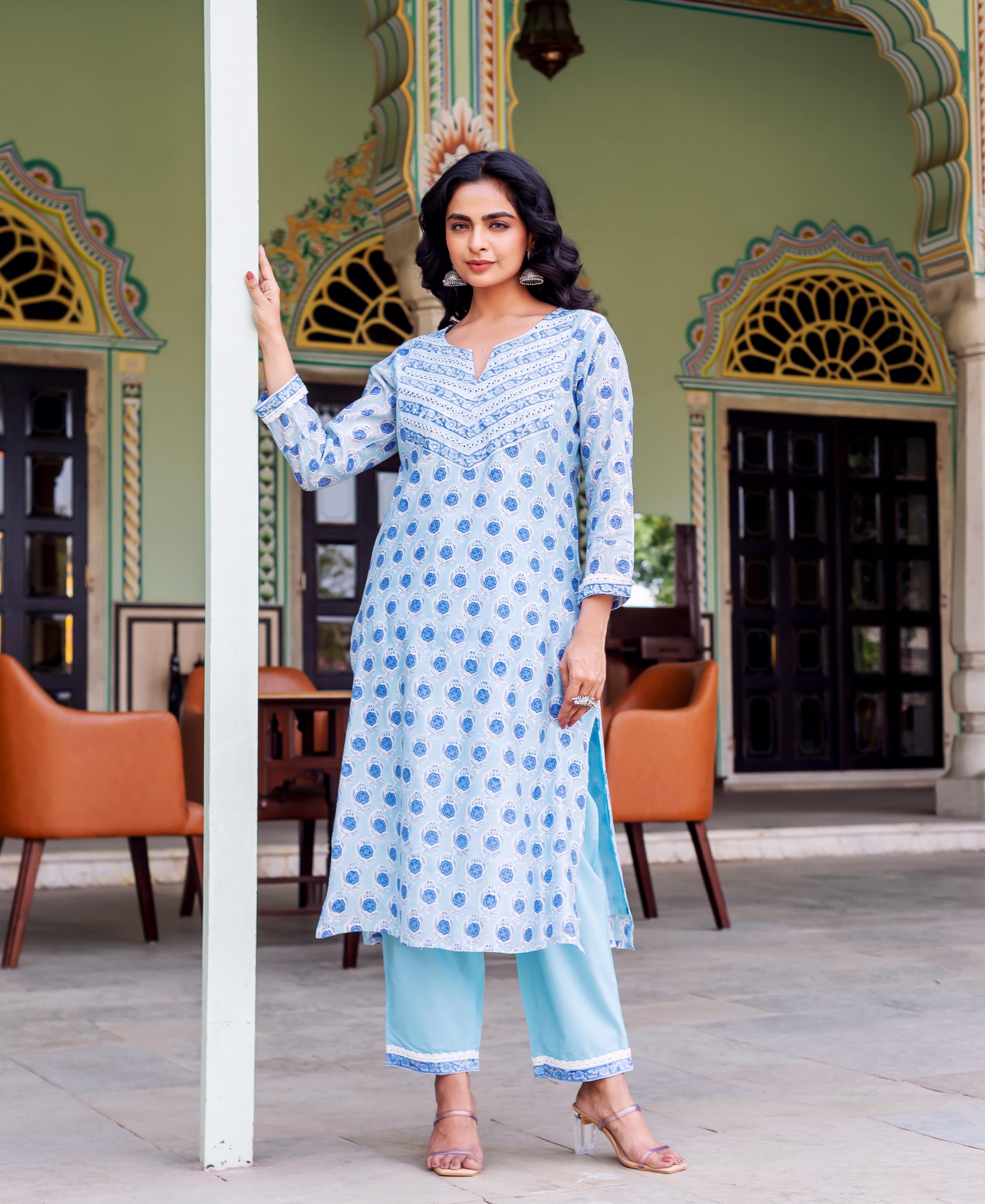 Model in light blue ethnic hand-block-printed kurta set with patterned yoke and pants.