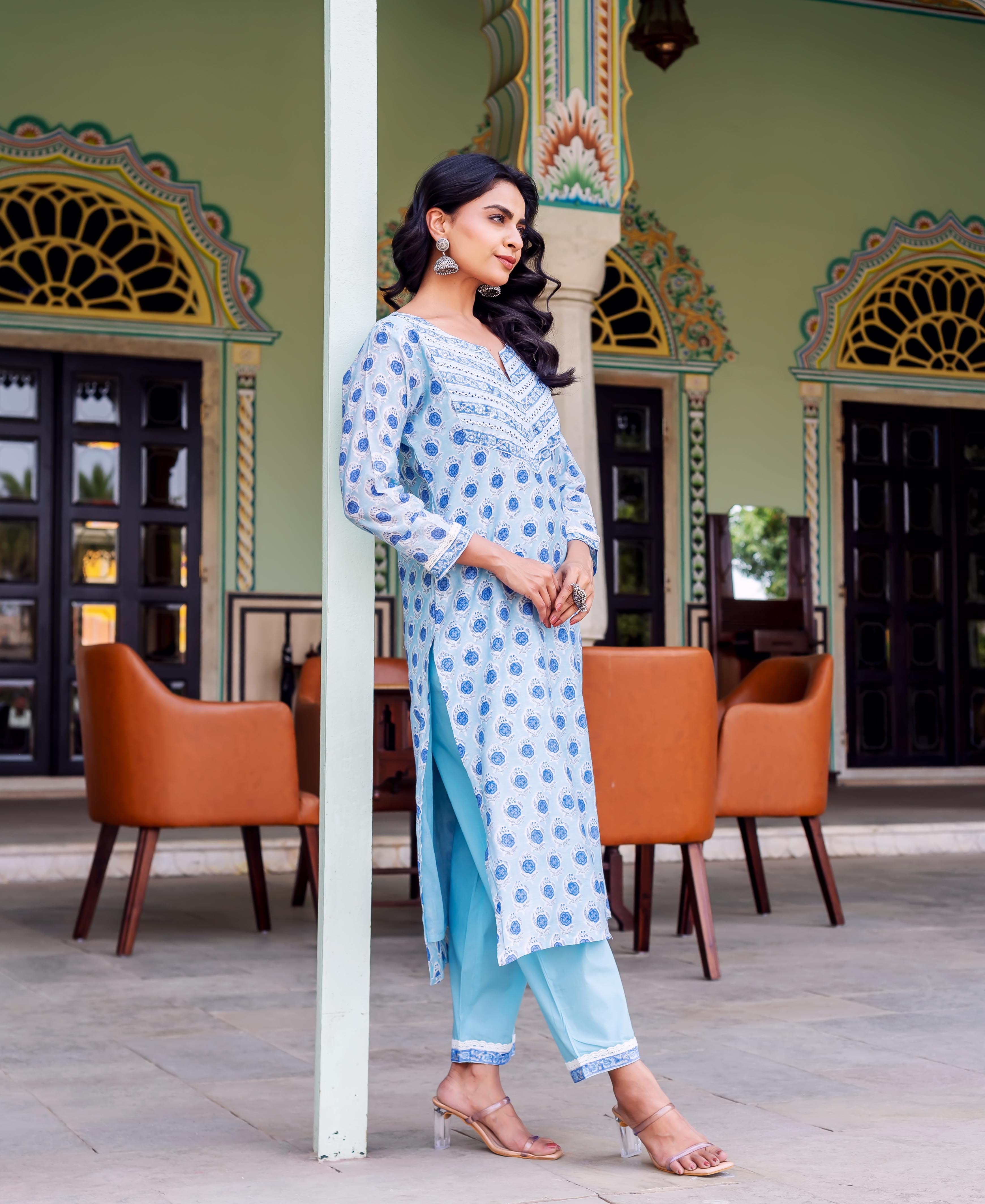 Full shot of a woman in a light blue hand-block-printed kurta with matching plain blue pants.