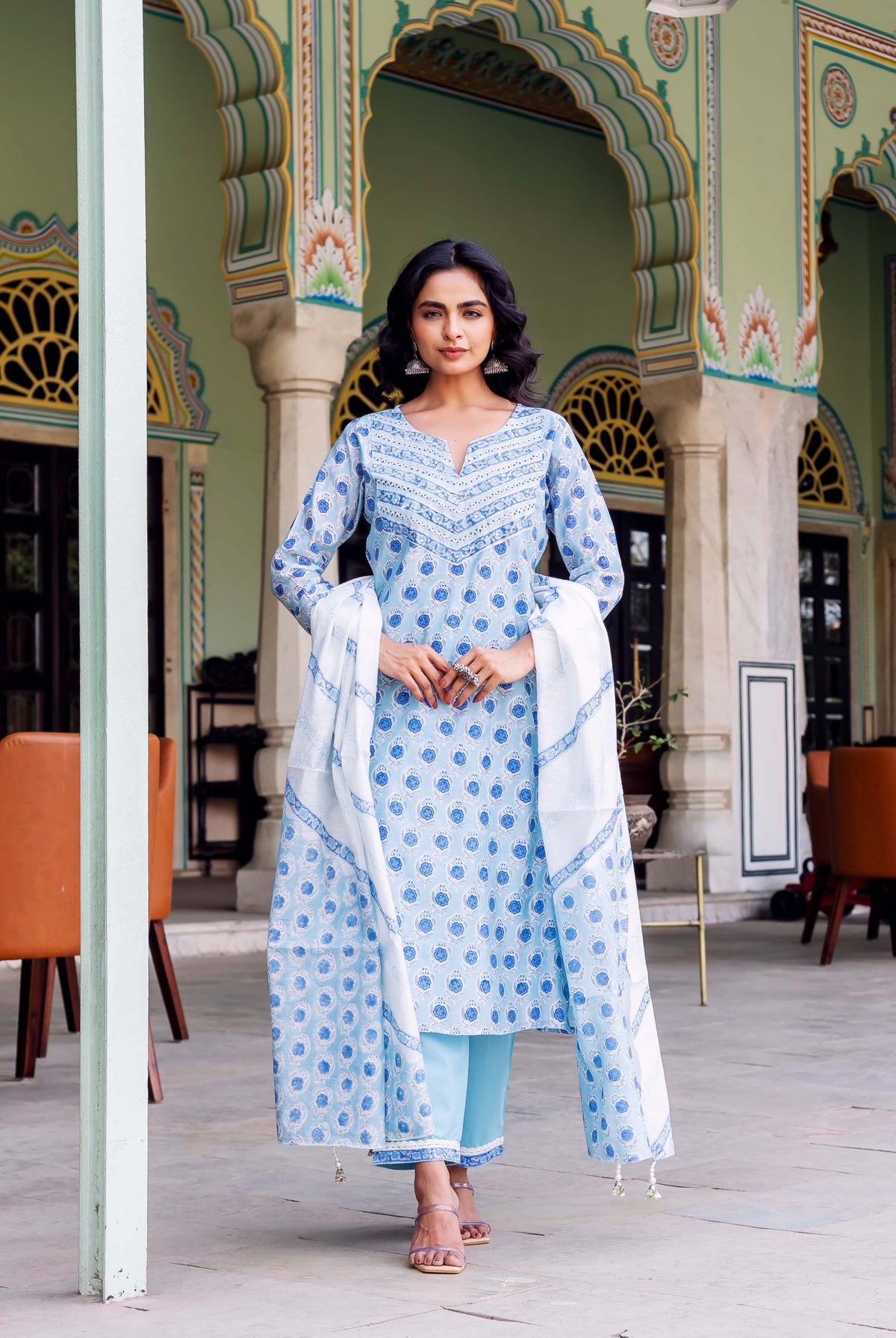 Model wearing light blue hand-block printed kurta set with blue and white patterned dupatta.