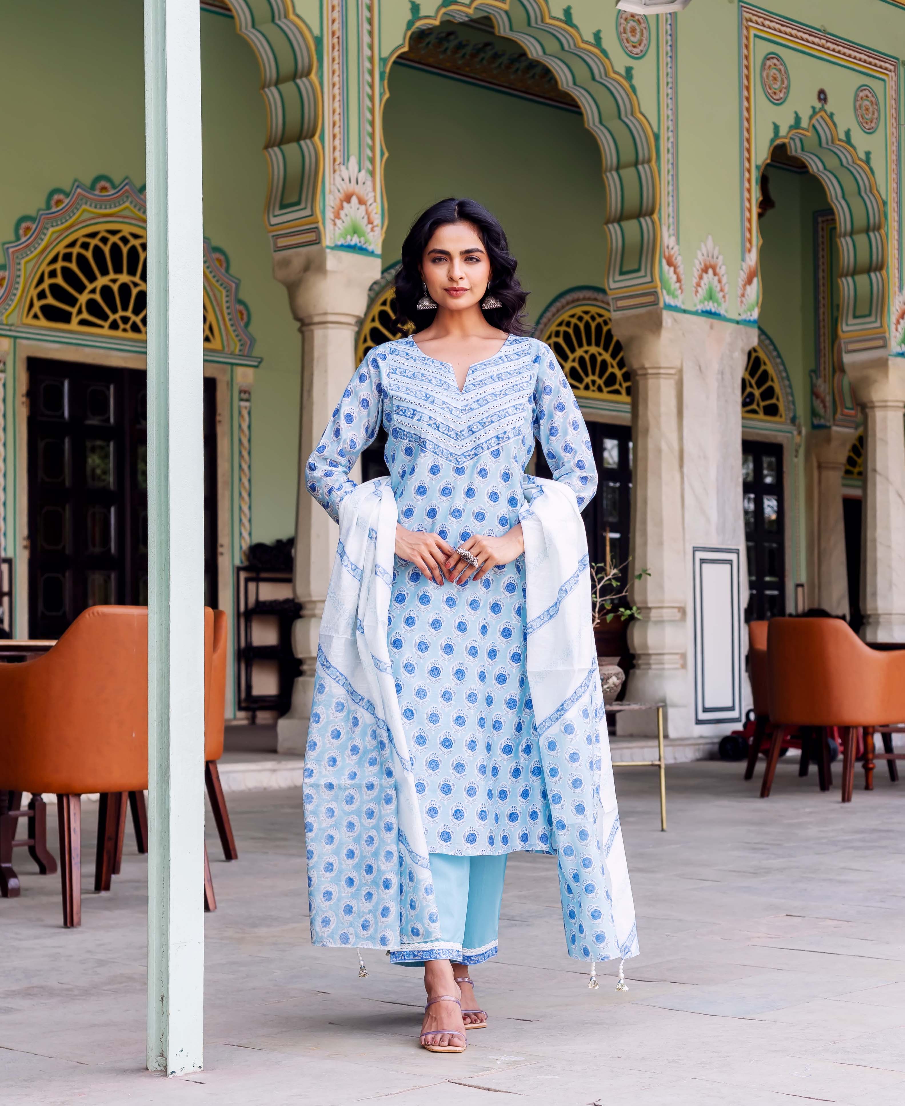 Model wearing light blue hand-block printed kurta set with blue and white patterned dupatta.
