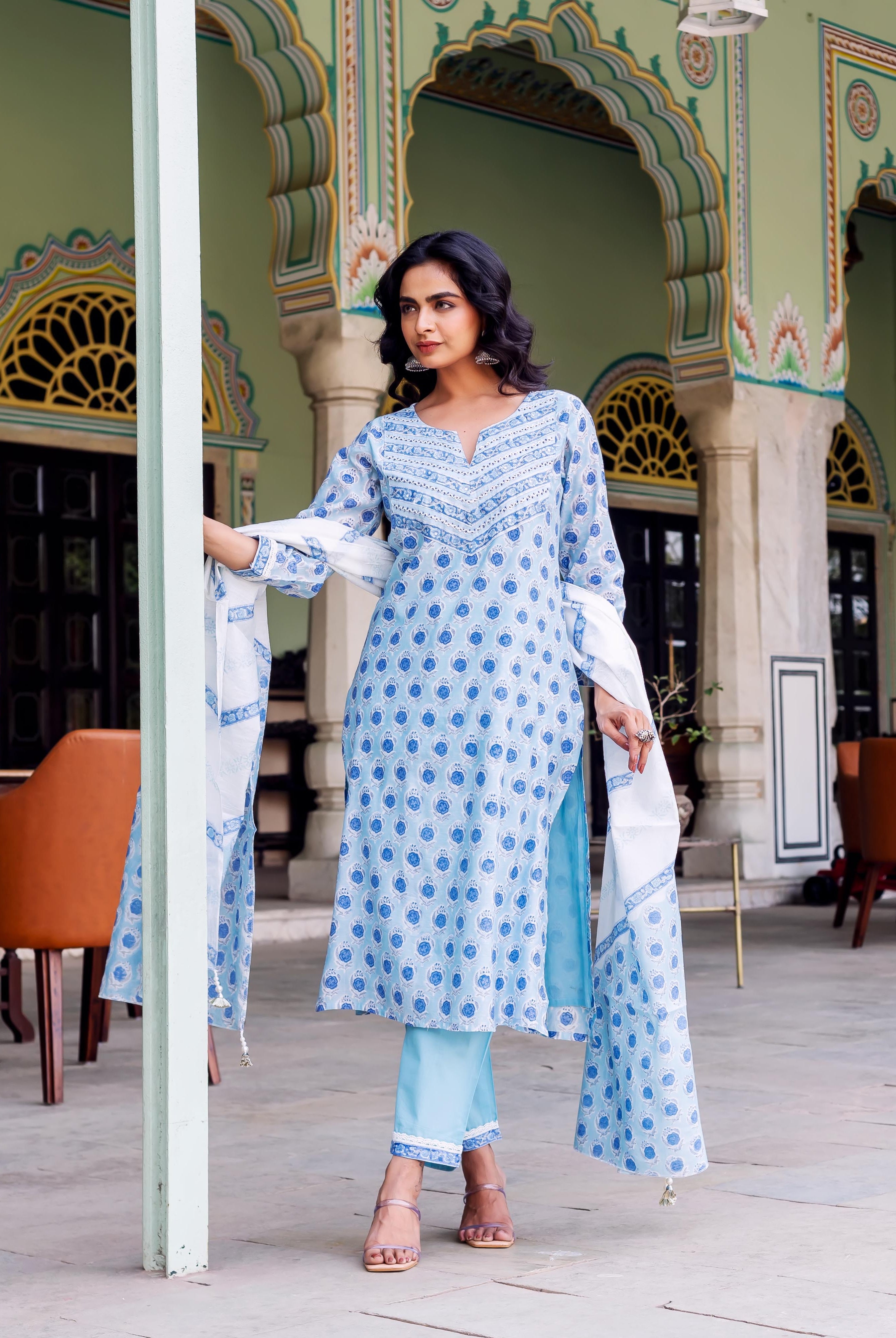 Standing model wearing a light blue kurta set with white dupatta, featuring blue circular block print.