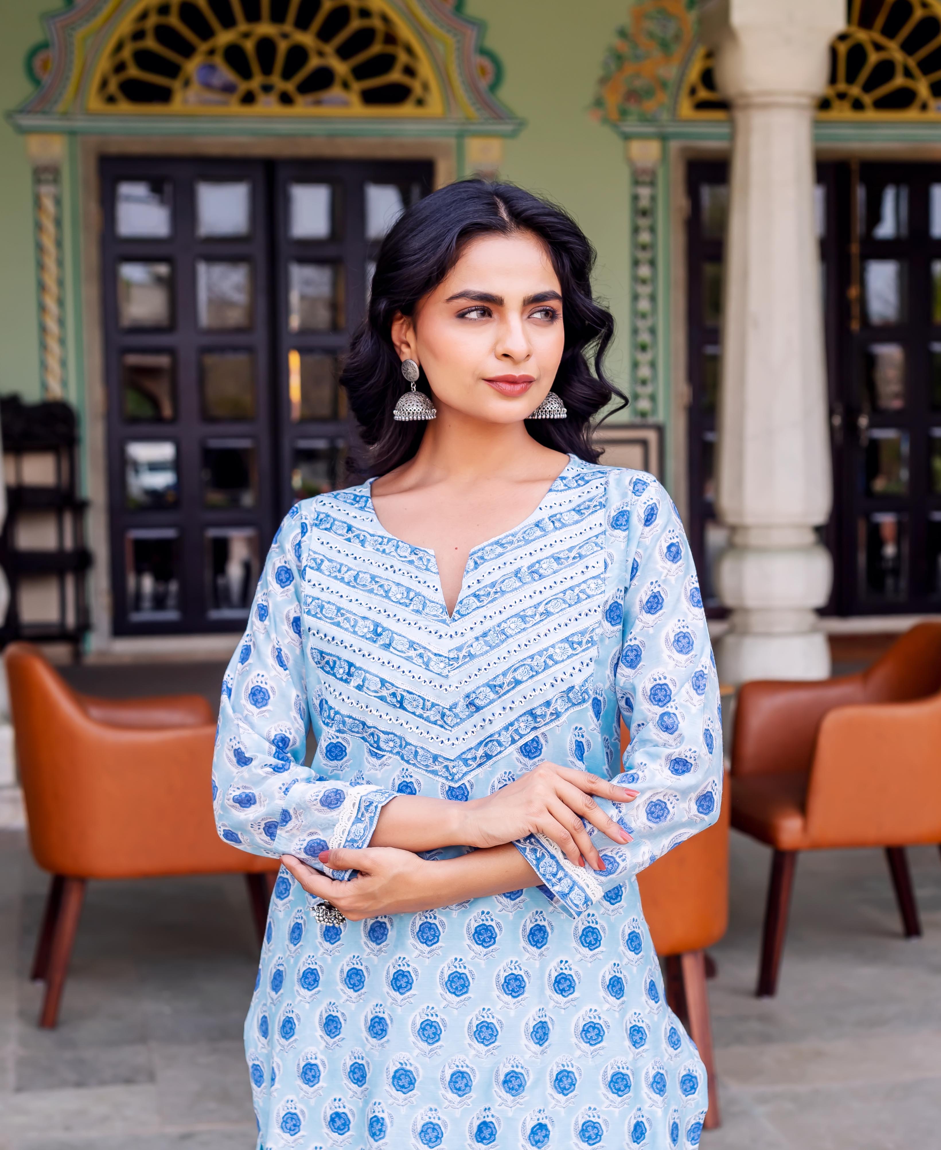 Model wears light blue hand-block printed Chanderi kurta featuring blue floral and geometric patterns.
