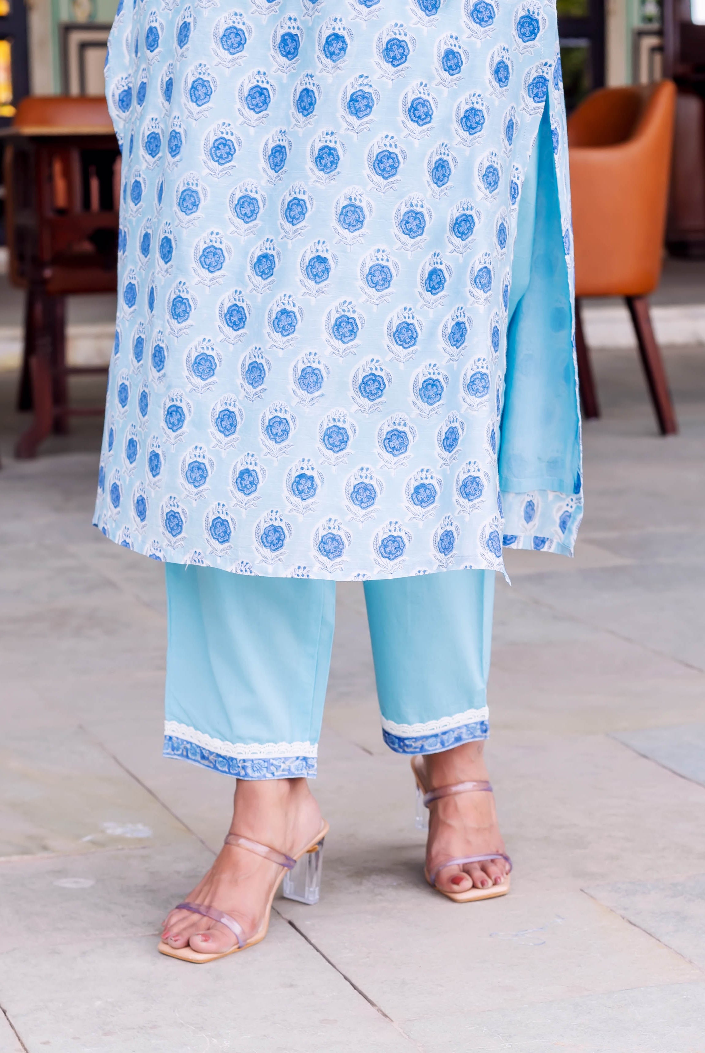 Close-up of model in pale blue kurta with blue medallion print and light blue pants.