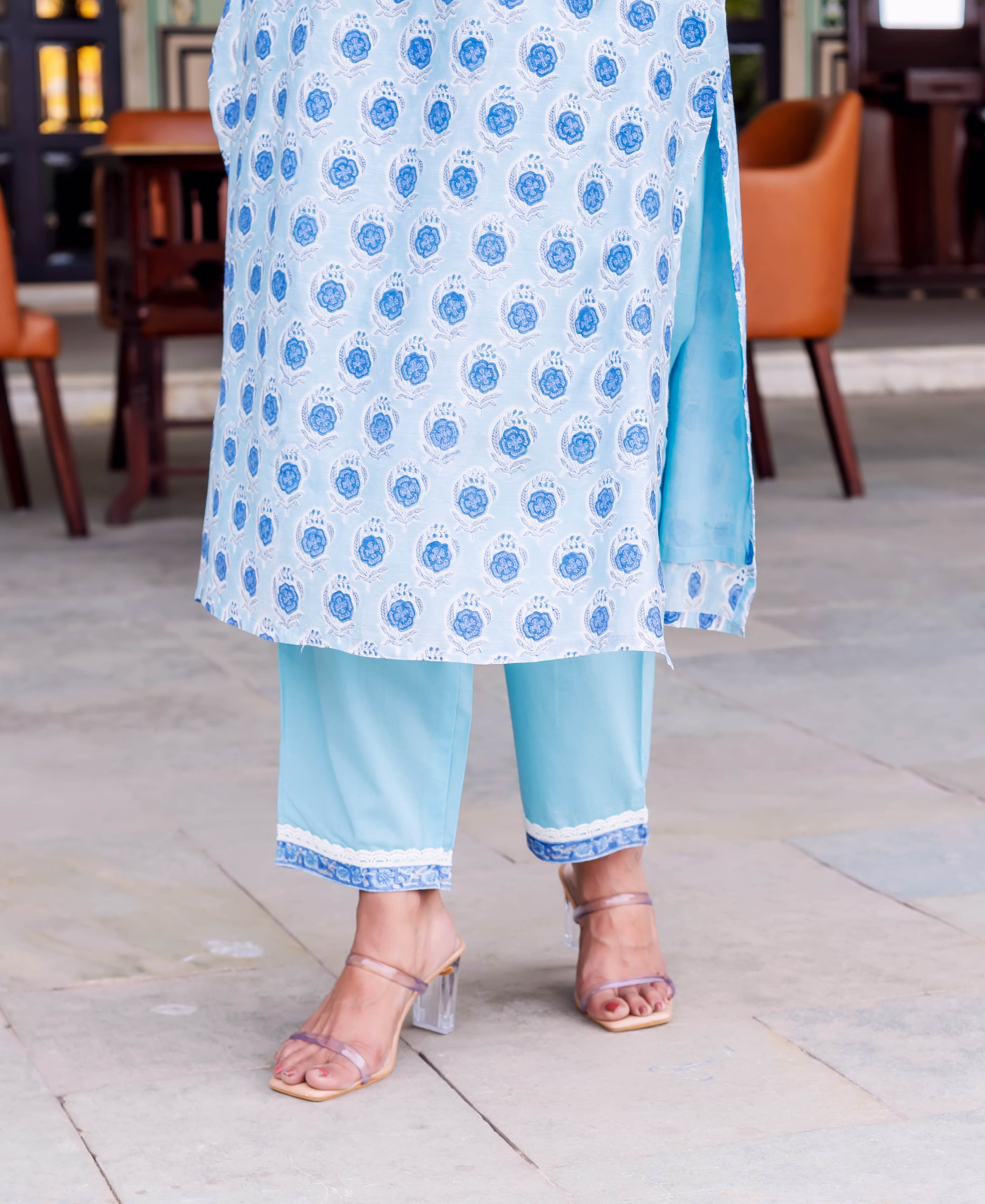 Close-up of model in pale blue kurta with blue medallion print and light blue pants.