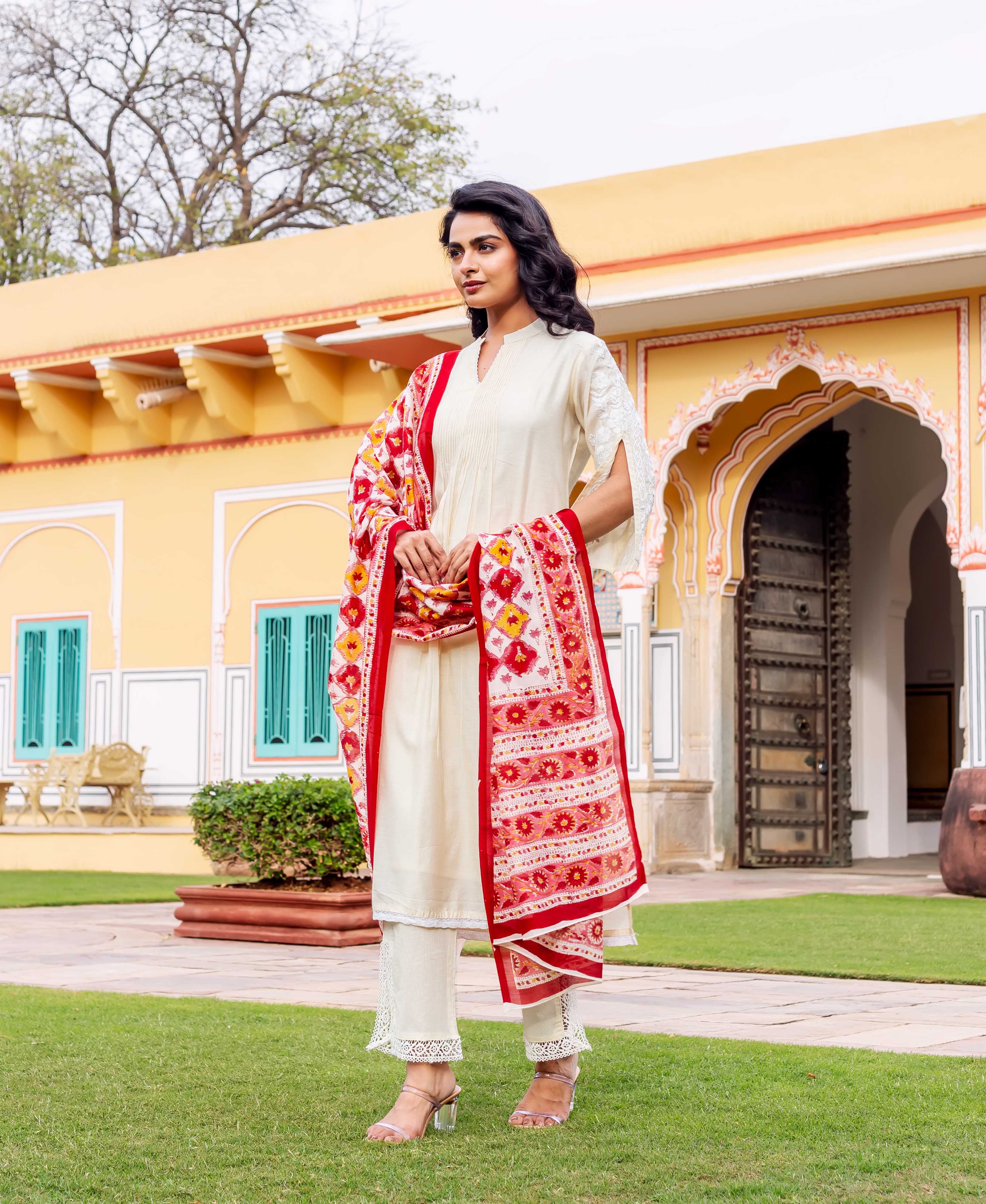 Antique white silk kurta with short sleeves and lace trim on model in garden setting.