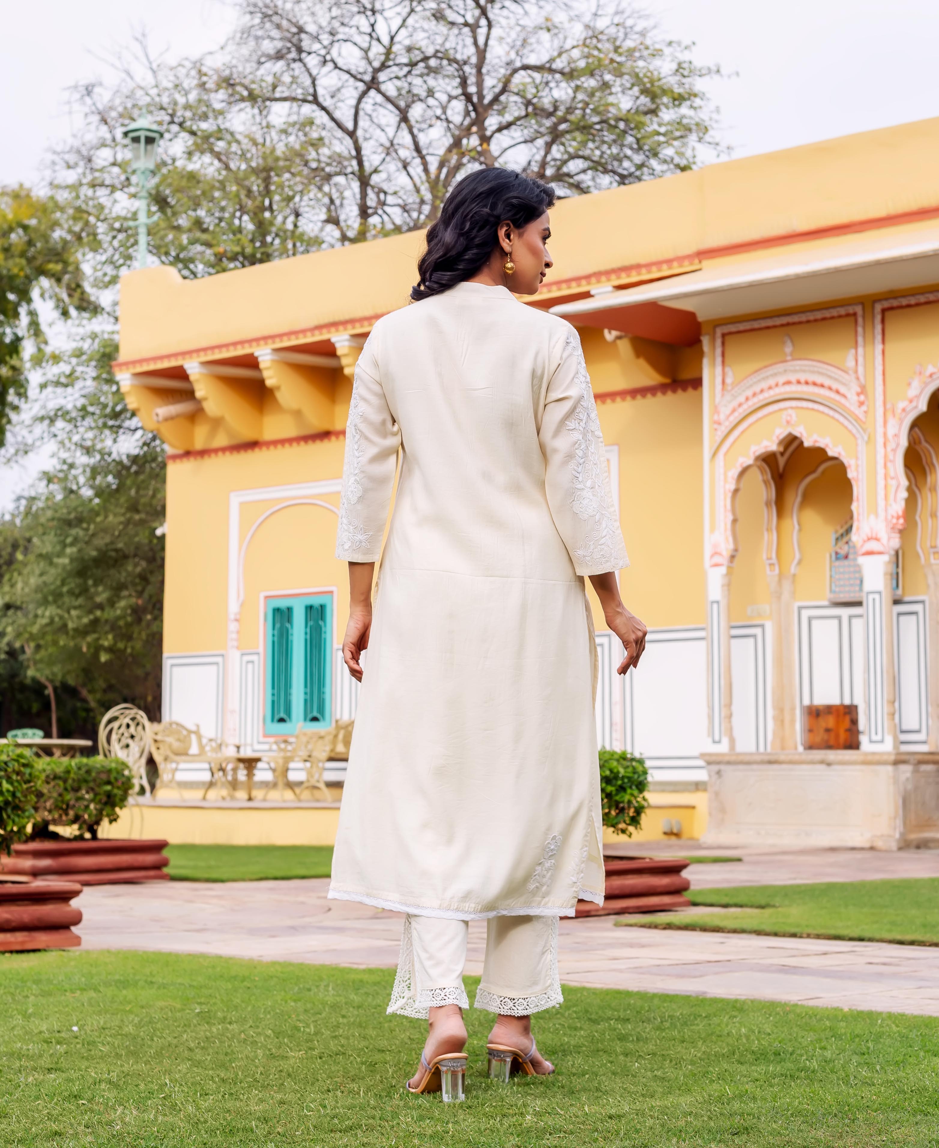 Back view of model wearing antique white ethnic kurta set with white embroidery.