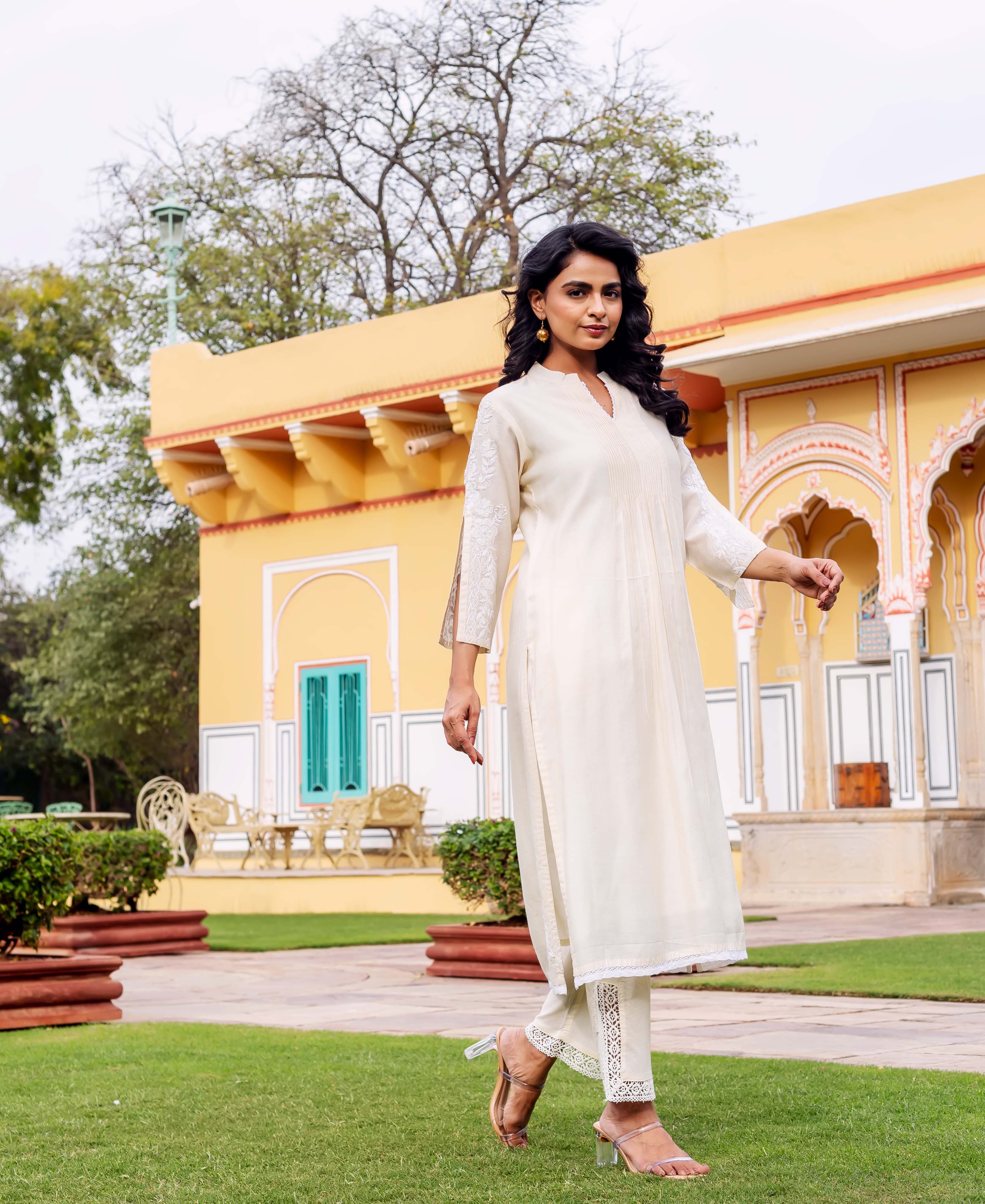 Model in antique white chanderi kurta with subtle hand-block print and lace-trimmed pants.