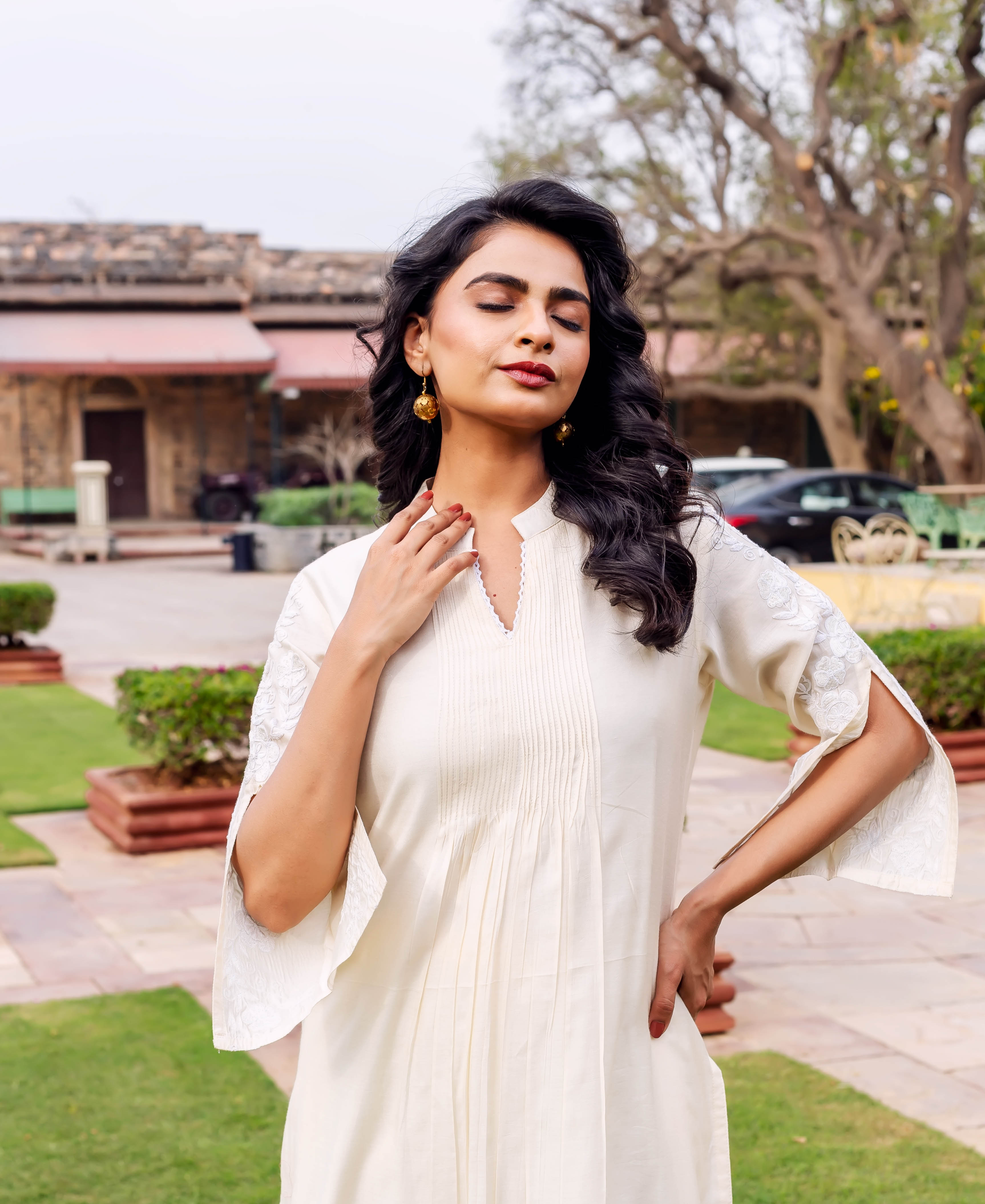 Model wears antique white silk chanderi kurta with front pintucks and subtle hand-block printed sleeves.