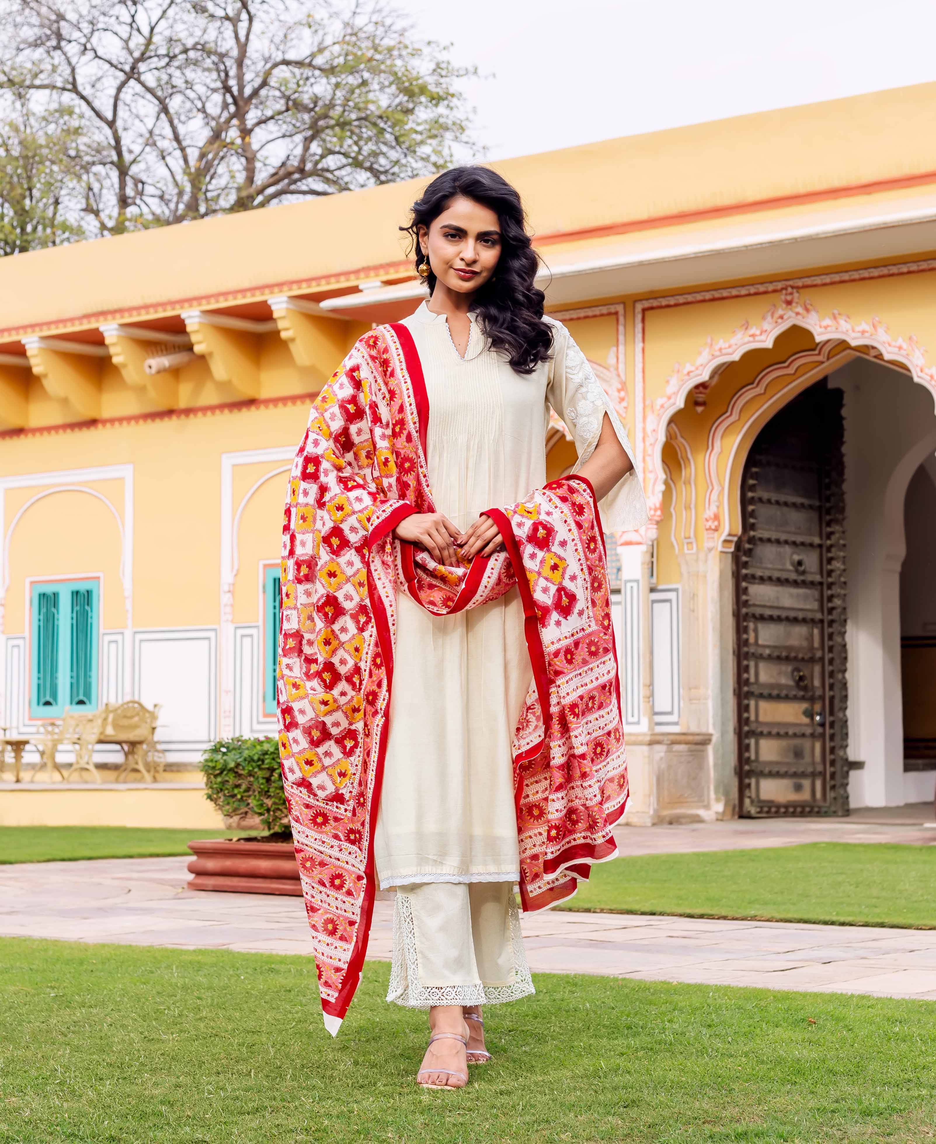 Front view model in antique white kurta set, vibrant red and yellow hand-block printed dupatta.