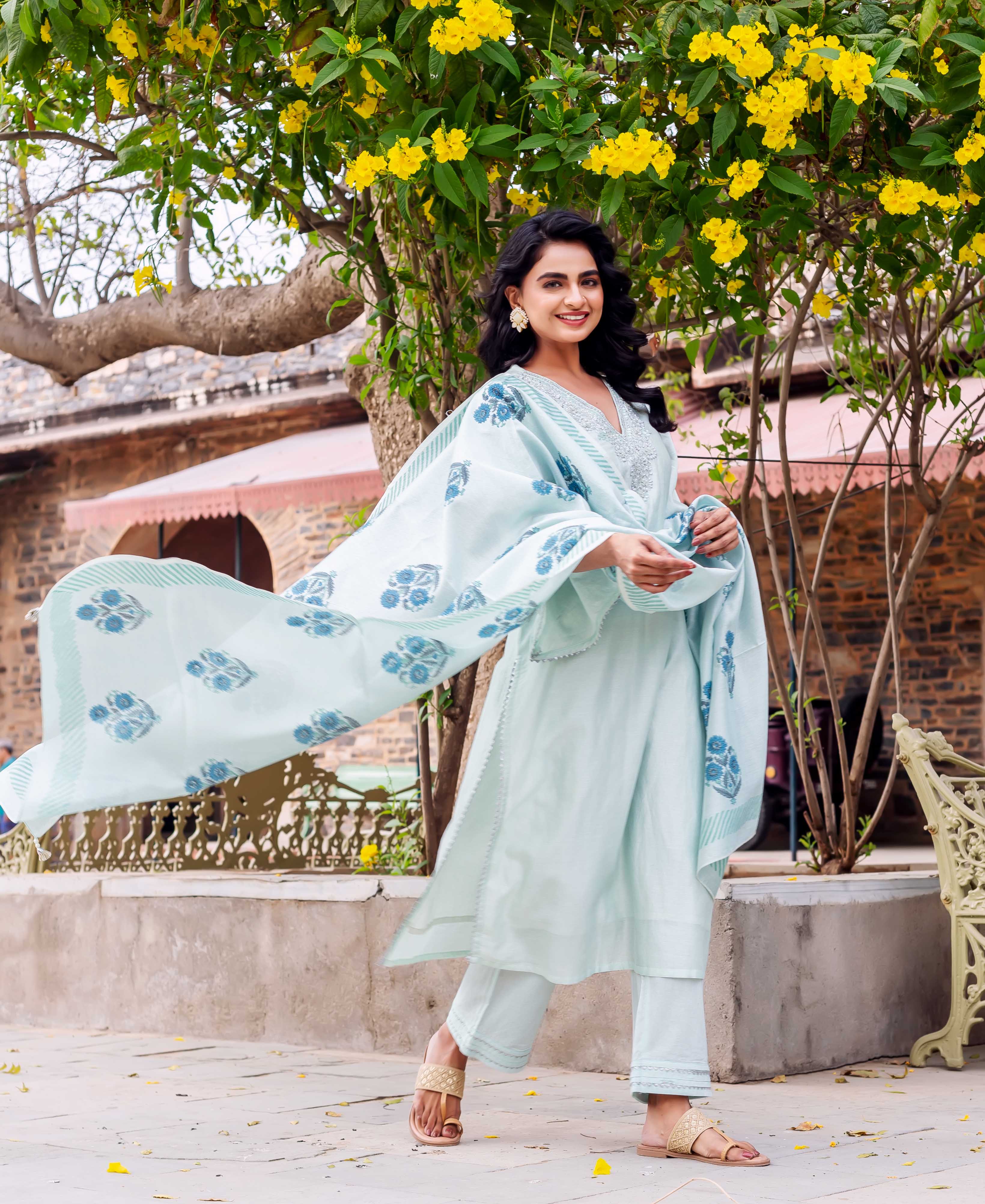 Model standing in mint chanderi silk kurta set with blue hand-block print dupatta.