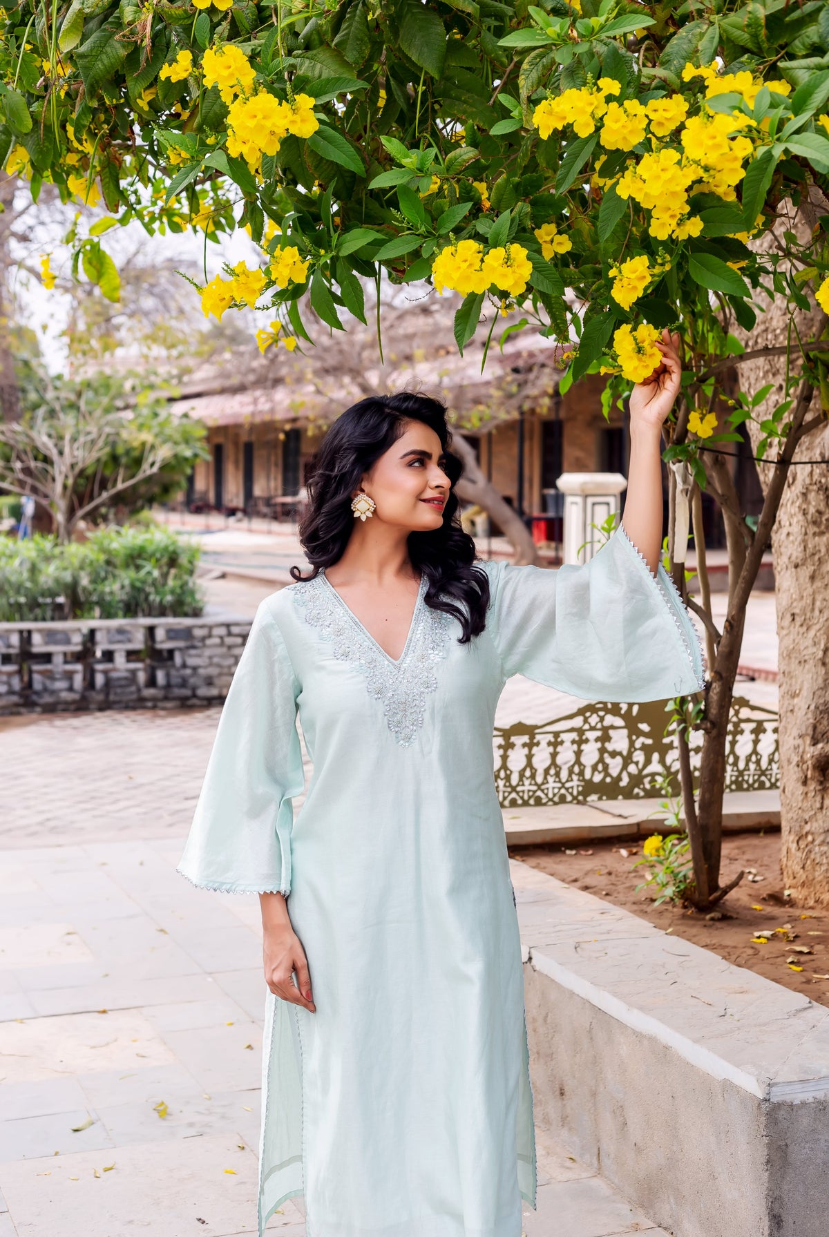 Model wears mint Chanderi silk kurta, silver embroidered V-neck and scalloped flared sleeves.