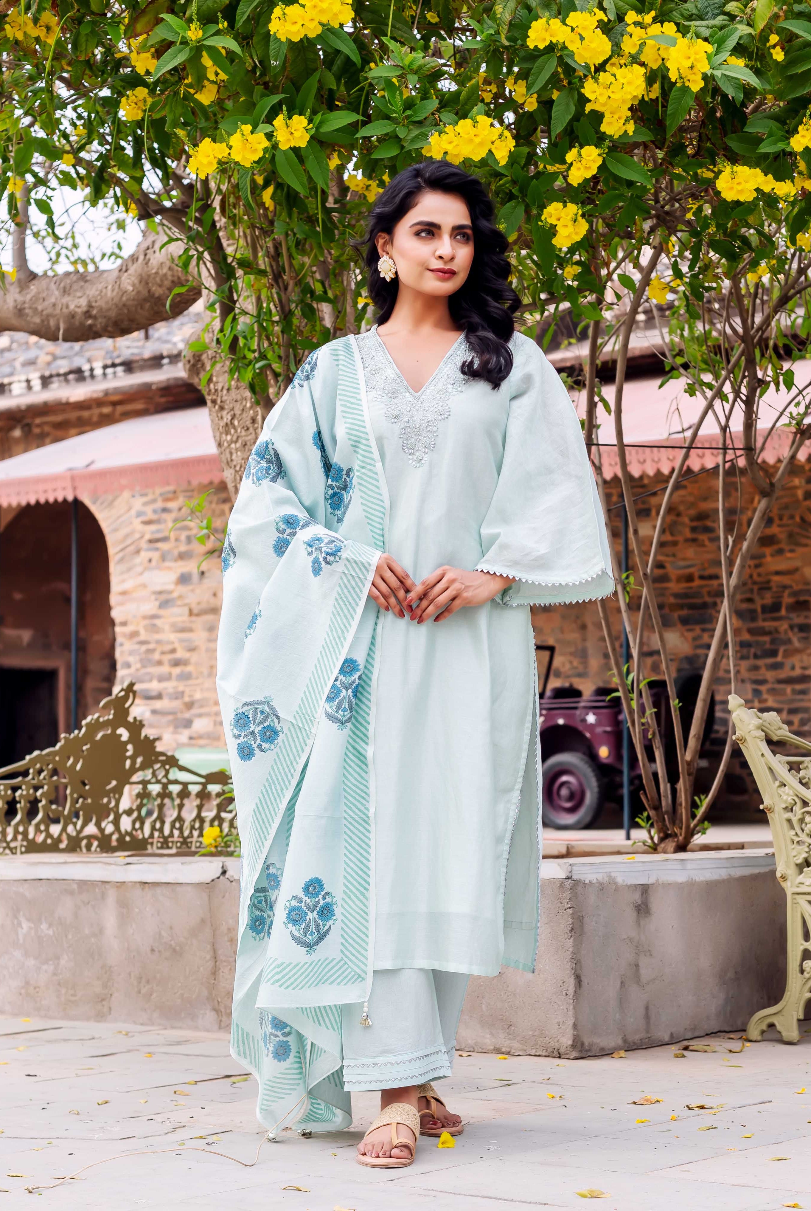 Front view model in a light mint hand-block printed kurta set with blue floral dupatta.