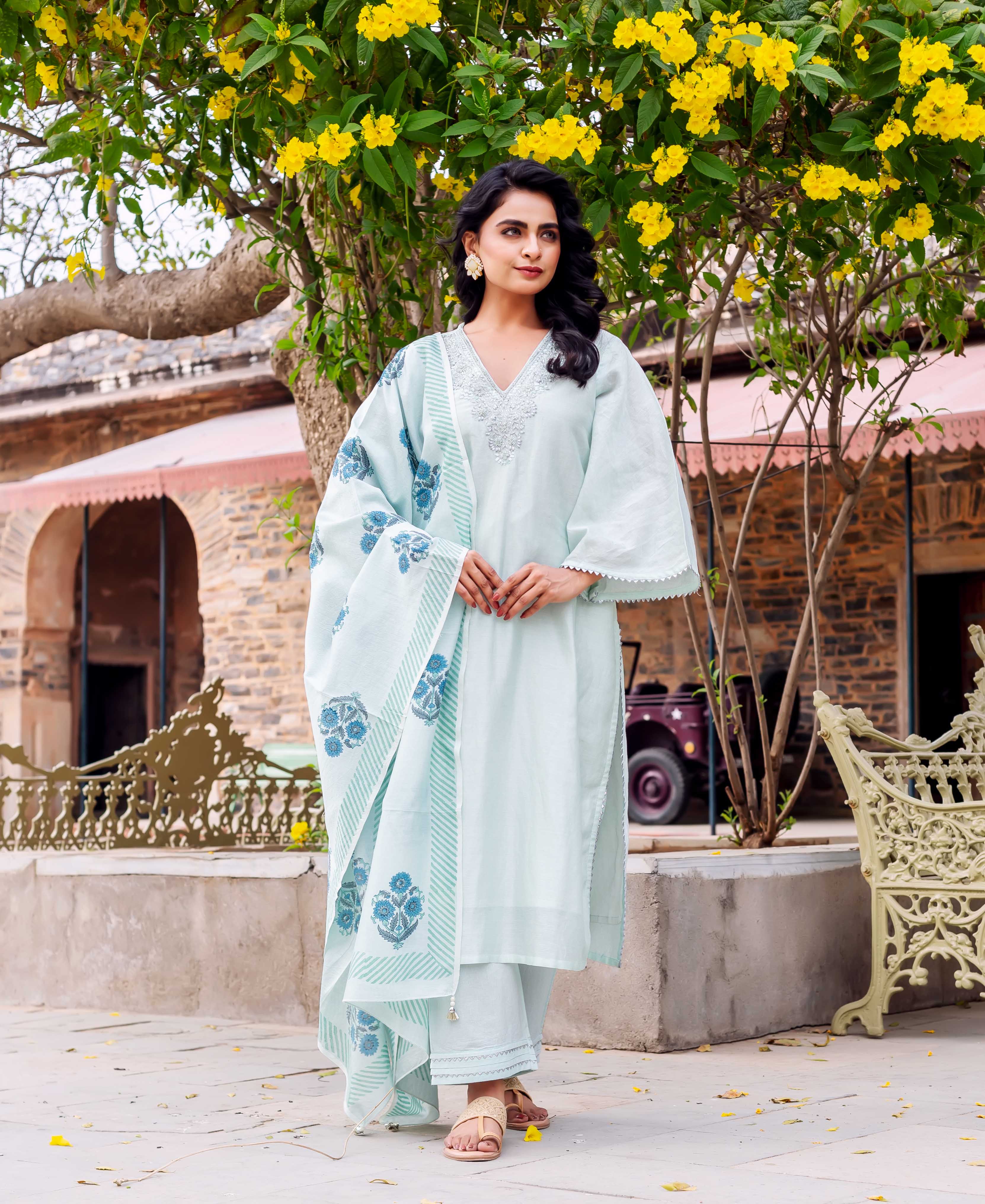 Front view model in a light mint hand-block printed kurta set with blue floral dupatta.