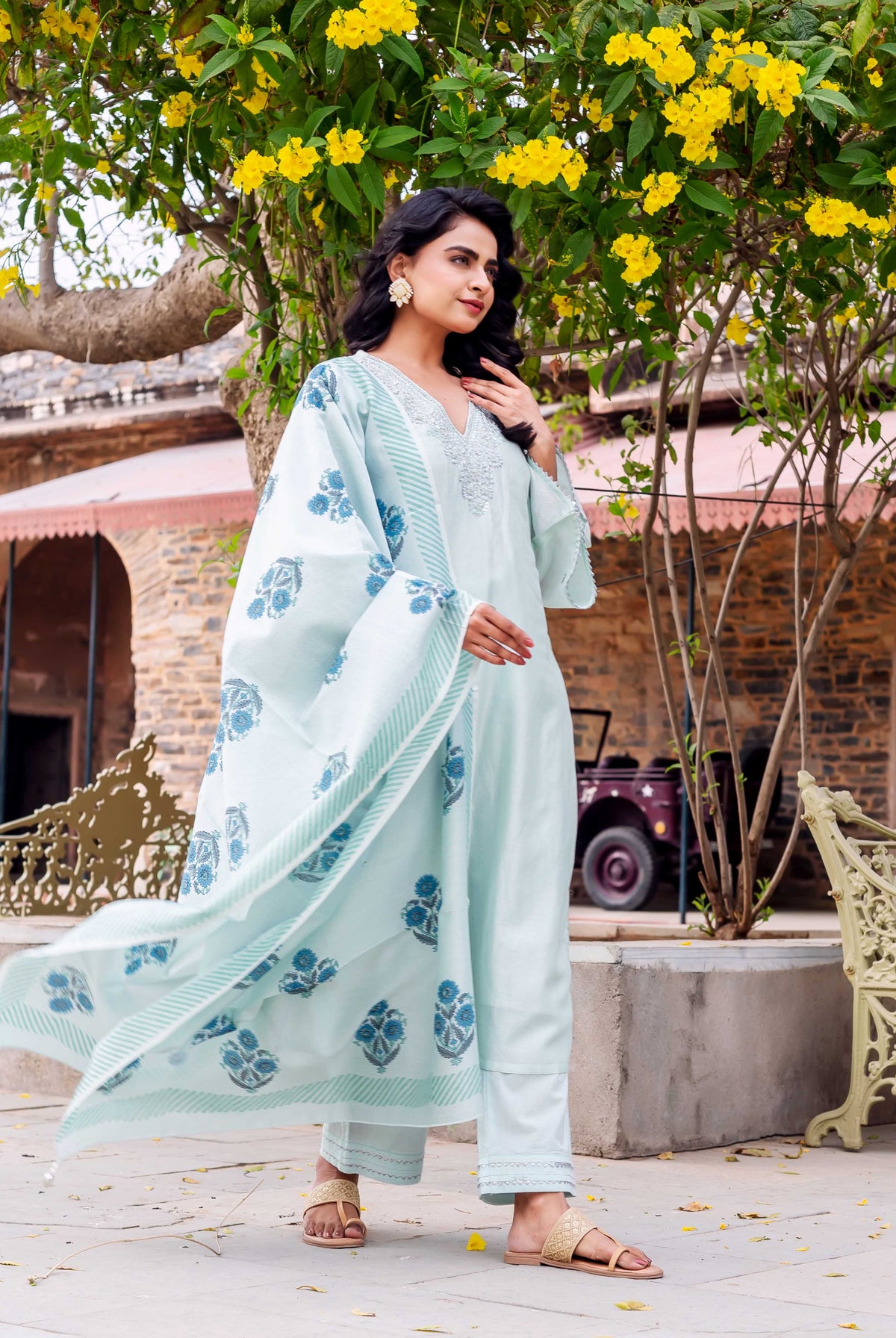 Model wearing mint Chanderi silk kurta set with embroidered neckline and blue hand-block-printed dupatta.