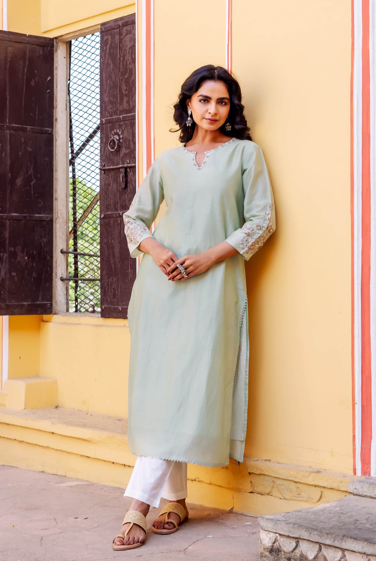 Front full look of model in mint green chanderi kurta with embroidered neckline and sleeves.