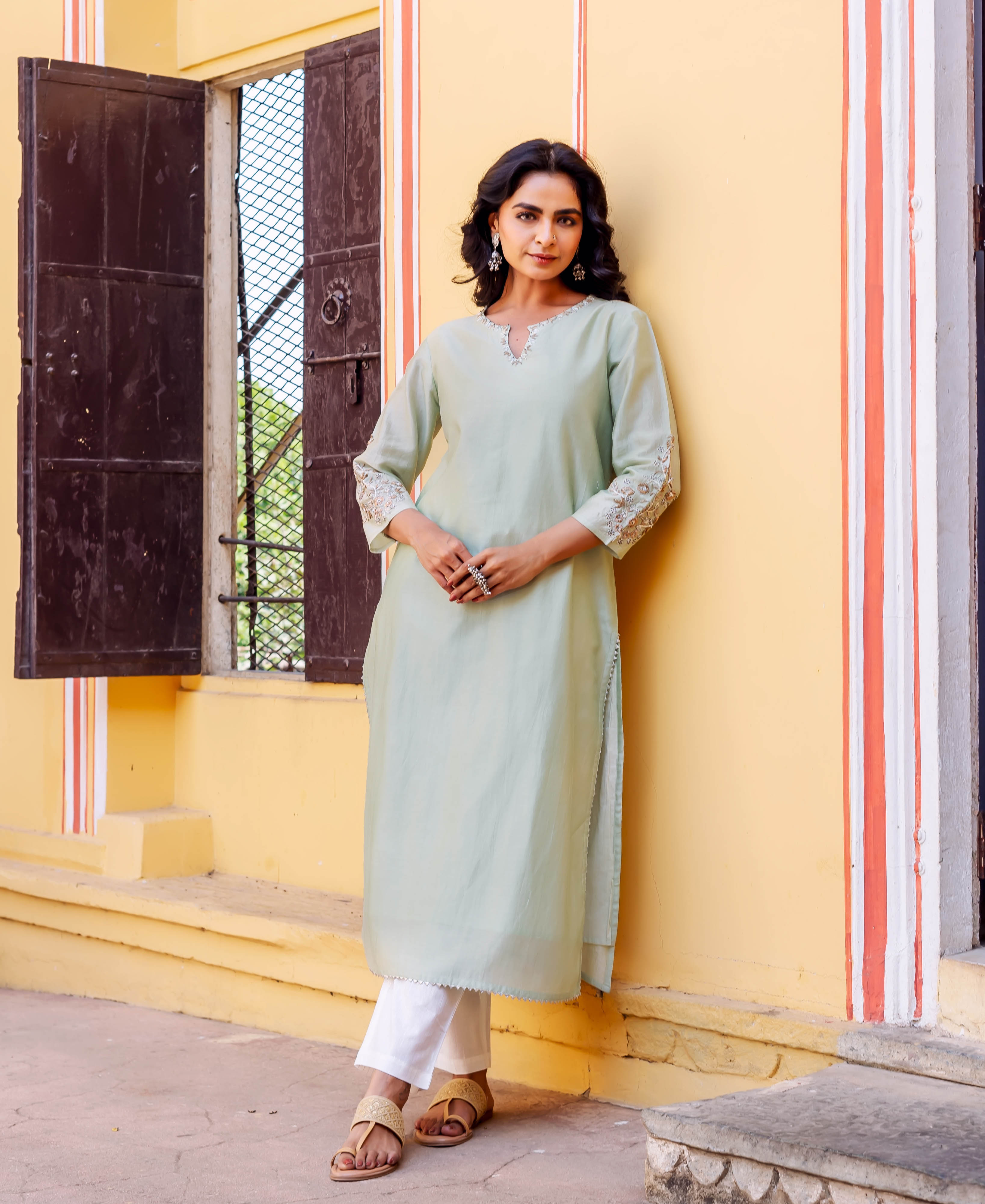 Front full look of model in mint green chanderi kurta with embroidered neckline and sleeves.