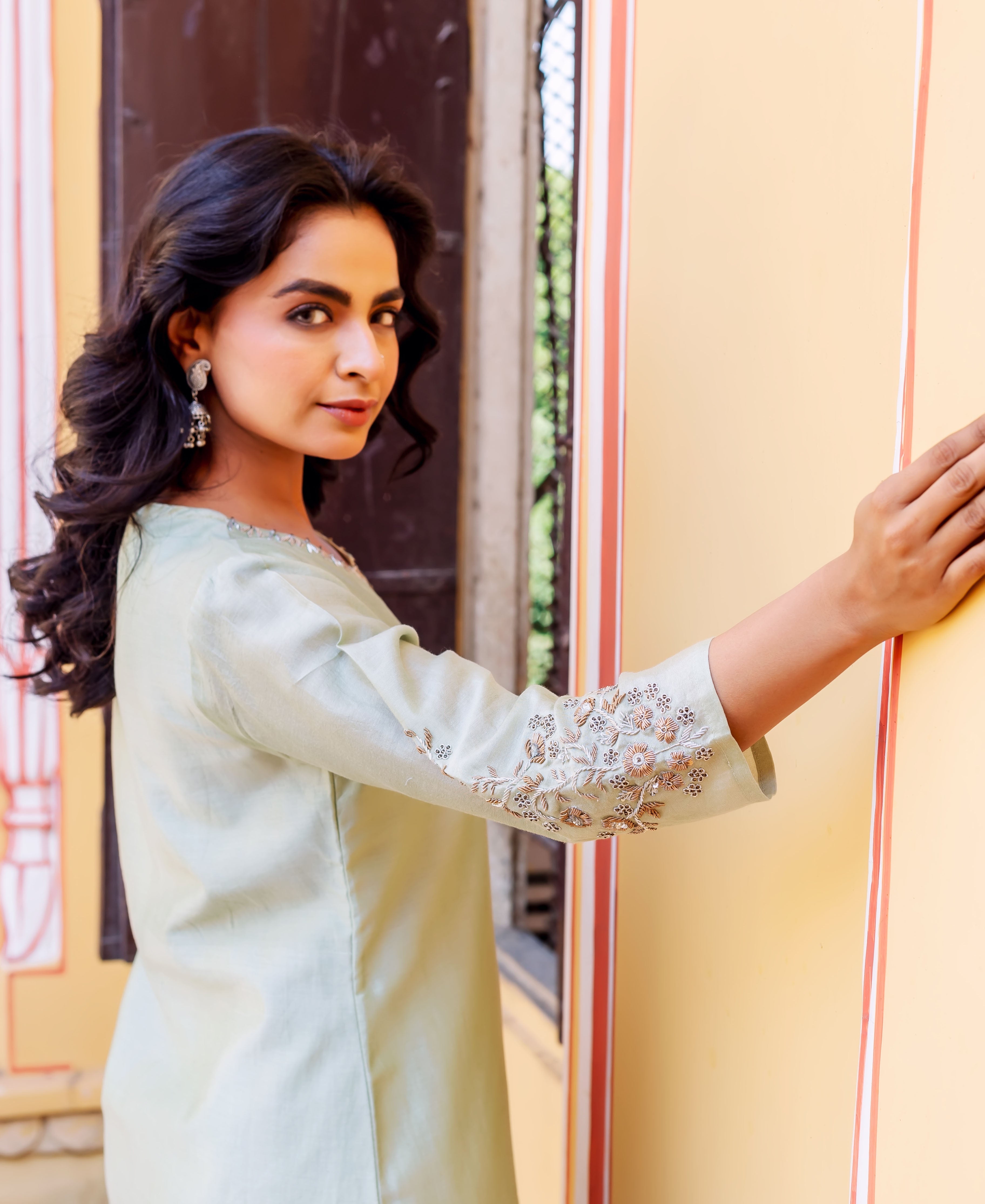Model in mint green chanderi kurta, side, showcasing intricately embroidered floral sleeves.