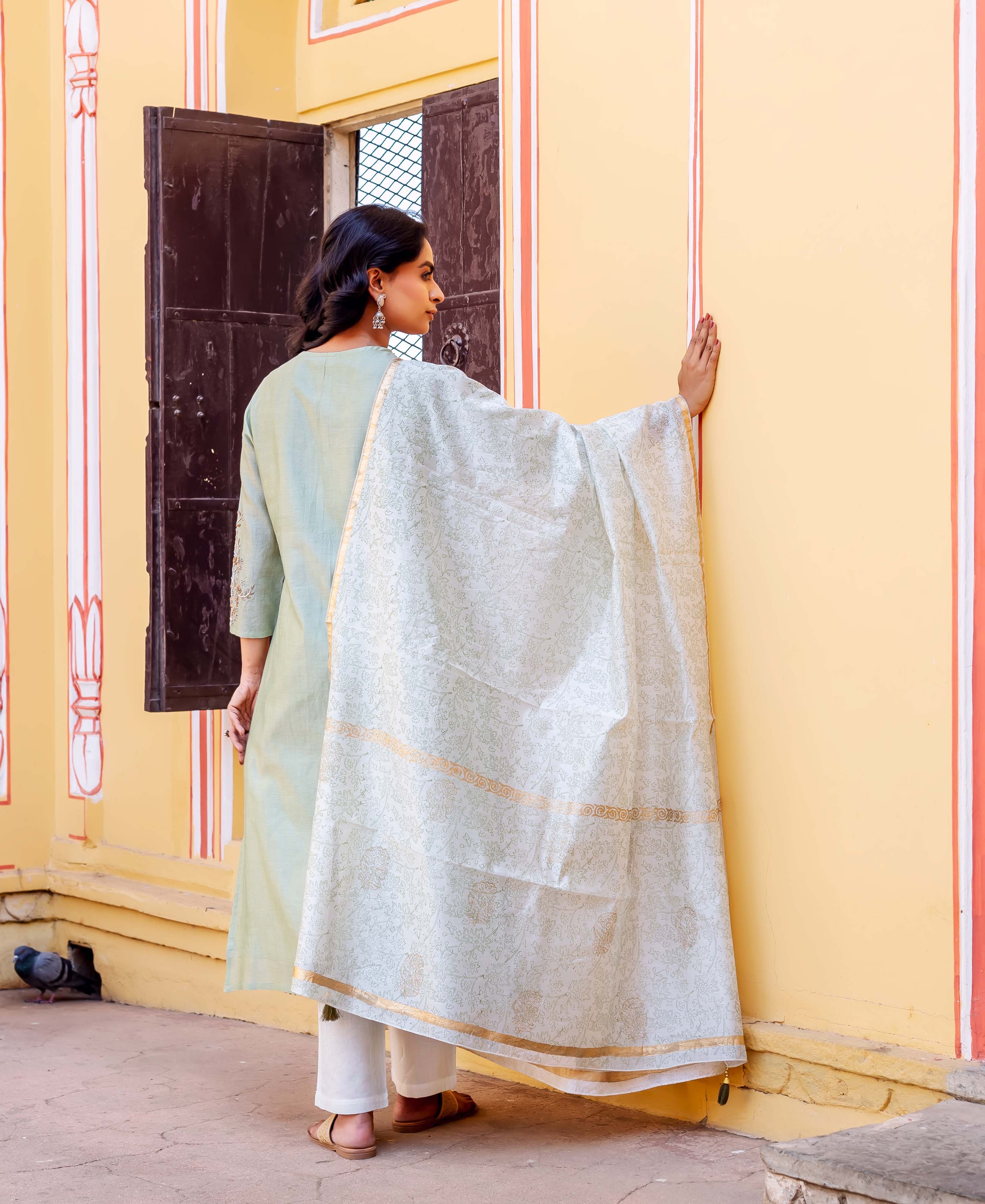 Model from back/side wearing mint green chanderi kurta, white bottoms, and block-printed dupatta.