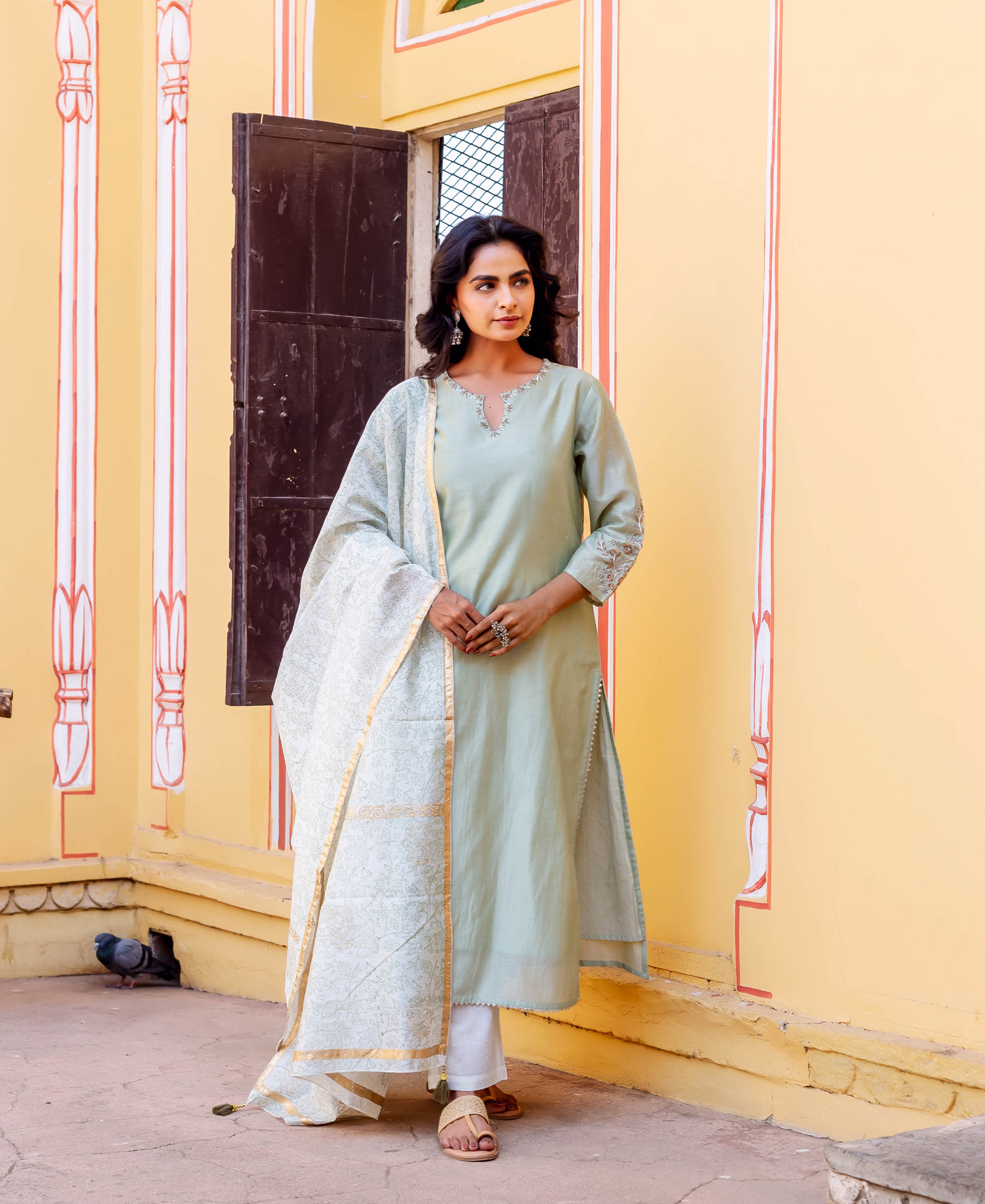 Front view of model in mint green chanderi kurta with embroidered sleeves, and block-printed dupatta.